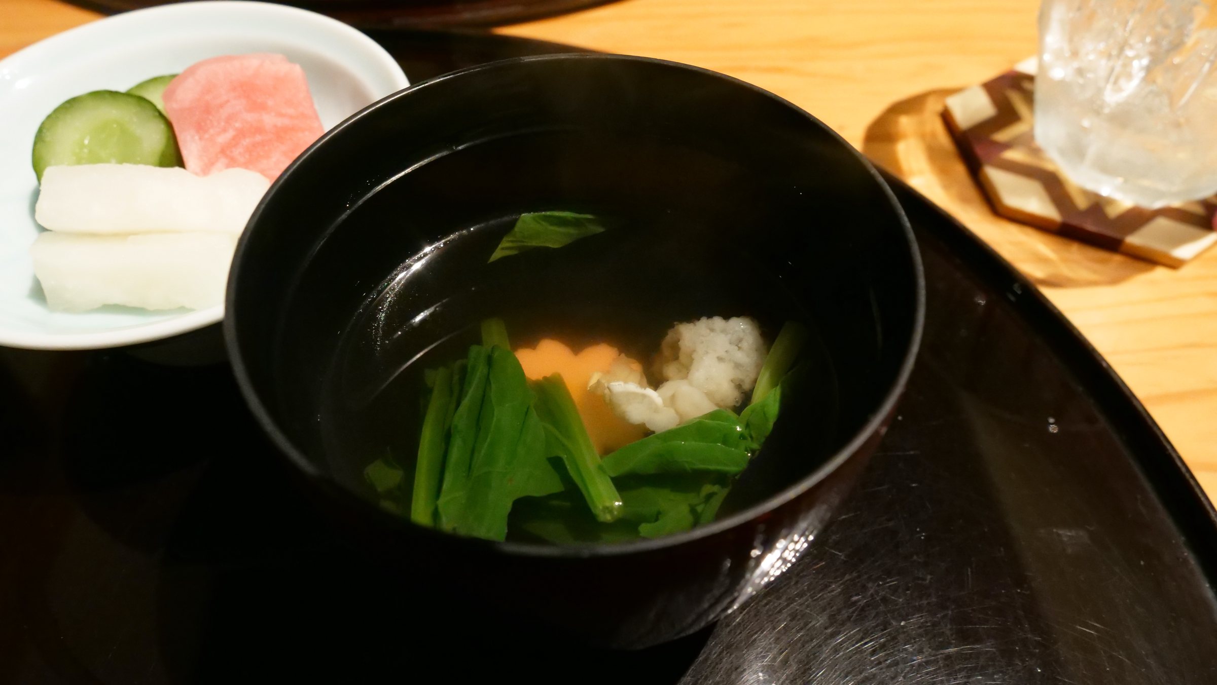 The soup course, greens in a clear broth.