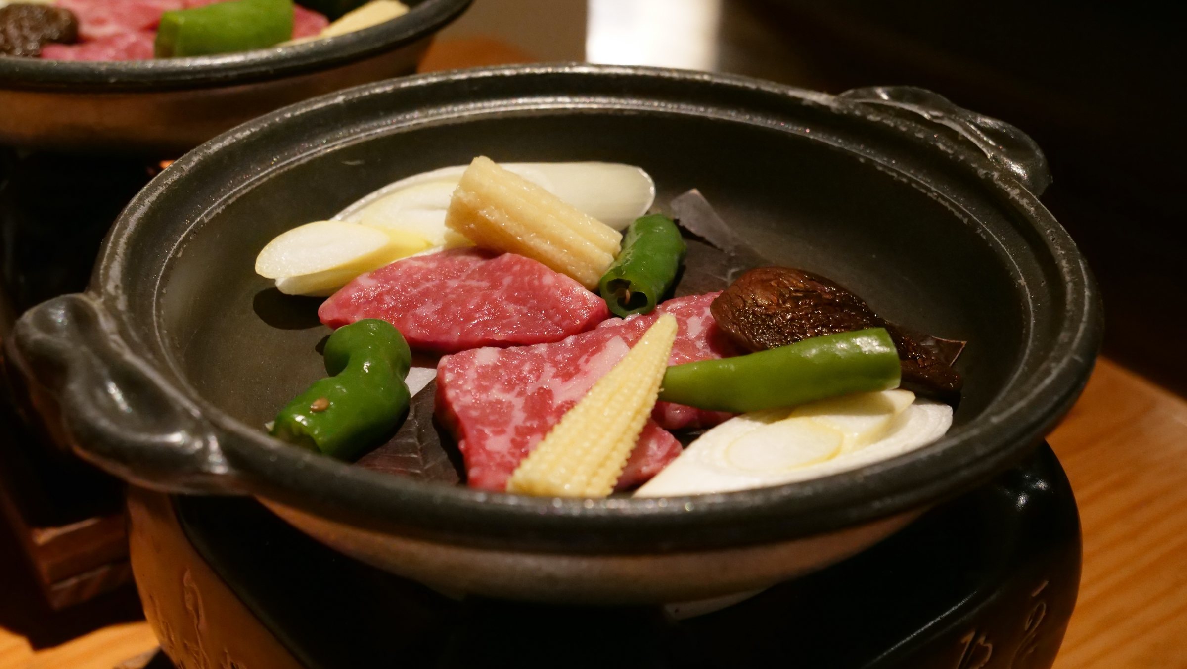 Ashigara beef with vegetables on an iron griddle.