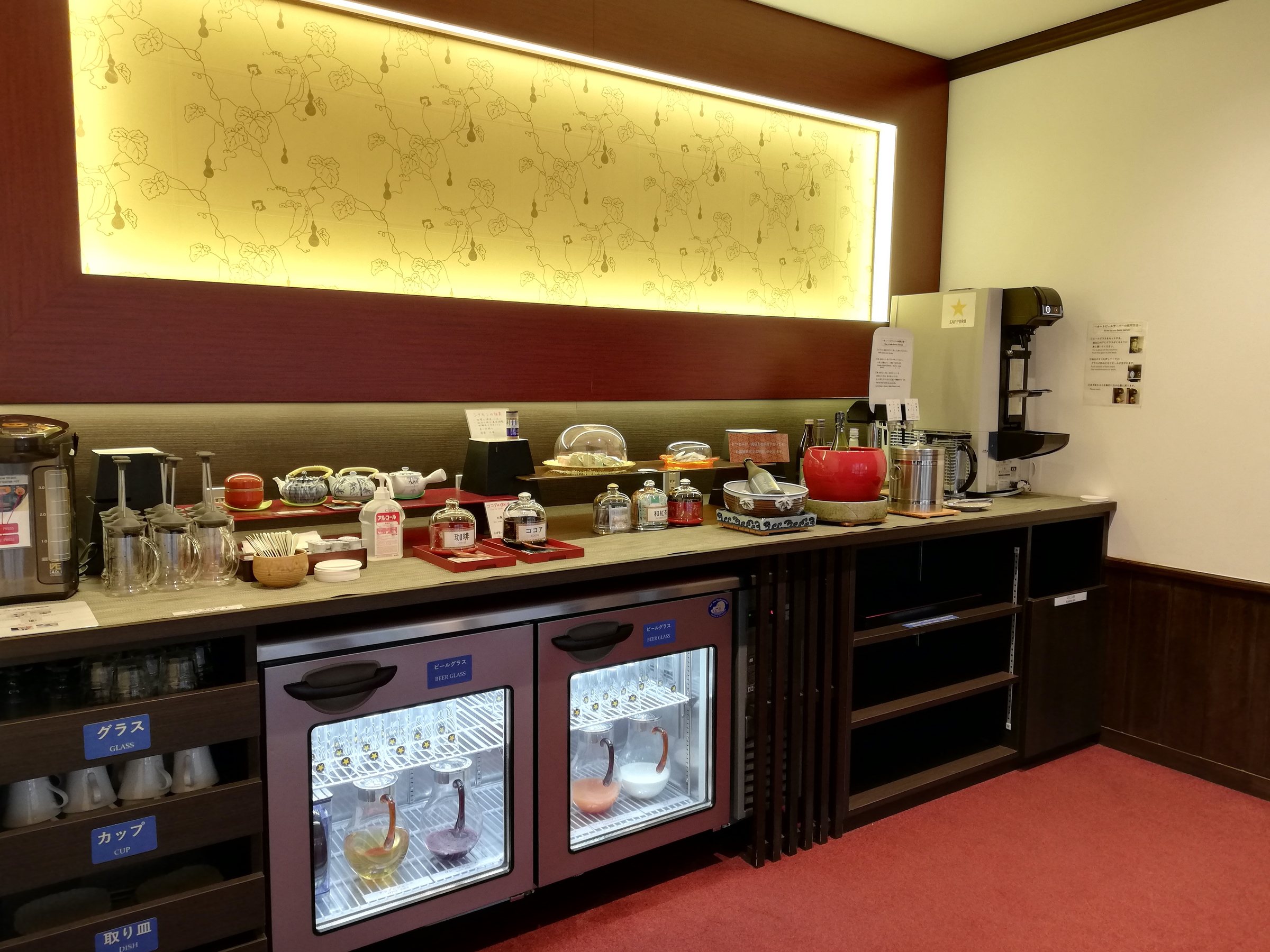The self-service drinks corner, with wine fridges and a coffee machine.