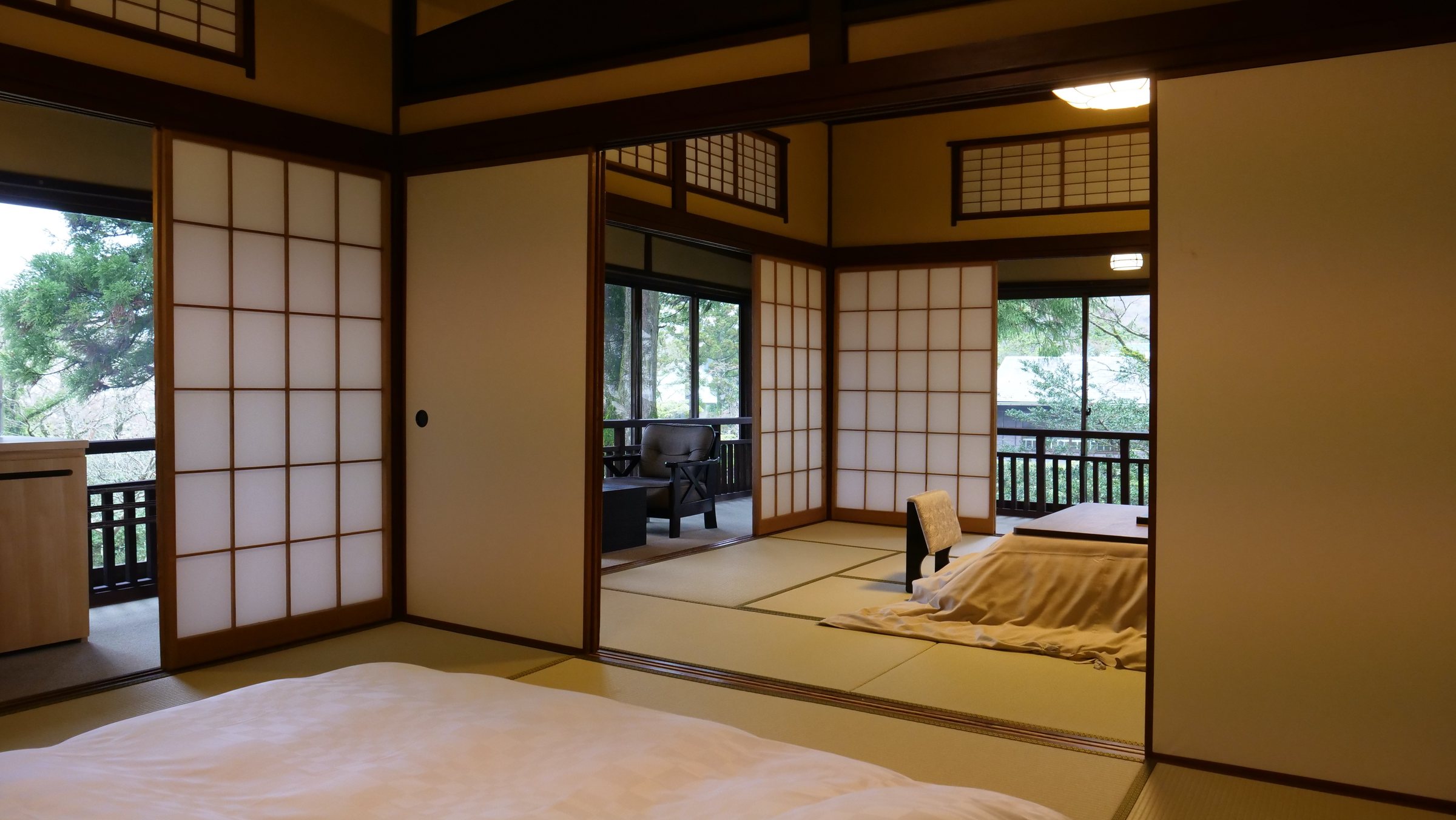 Interconnecting tatami rooms, with a kotatsu table at the far end.