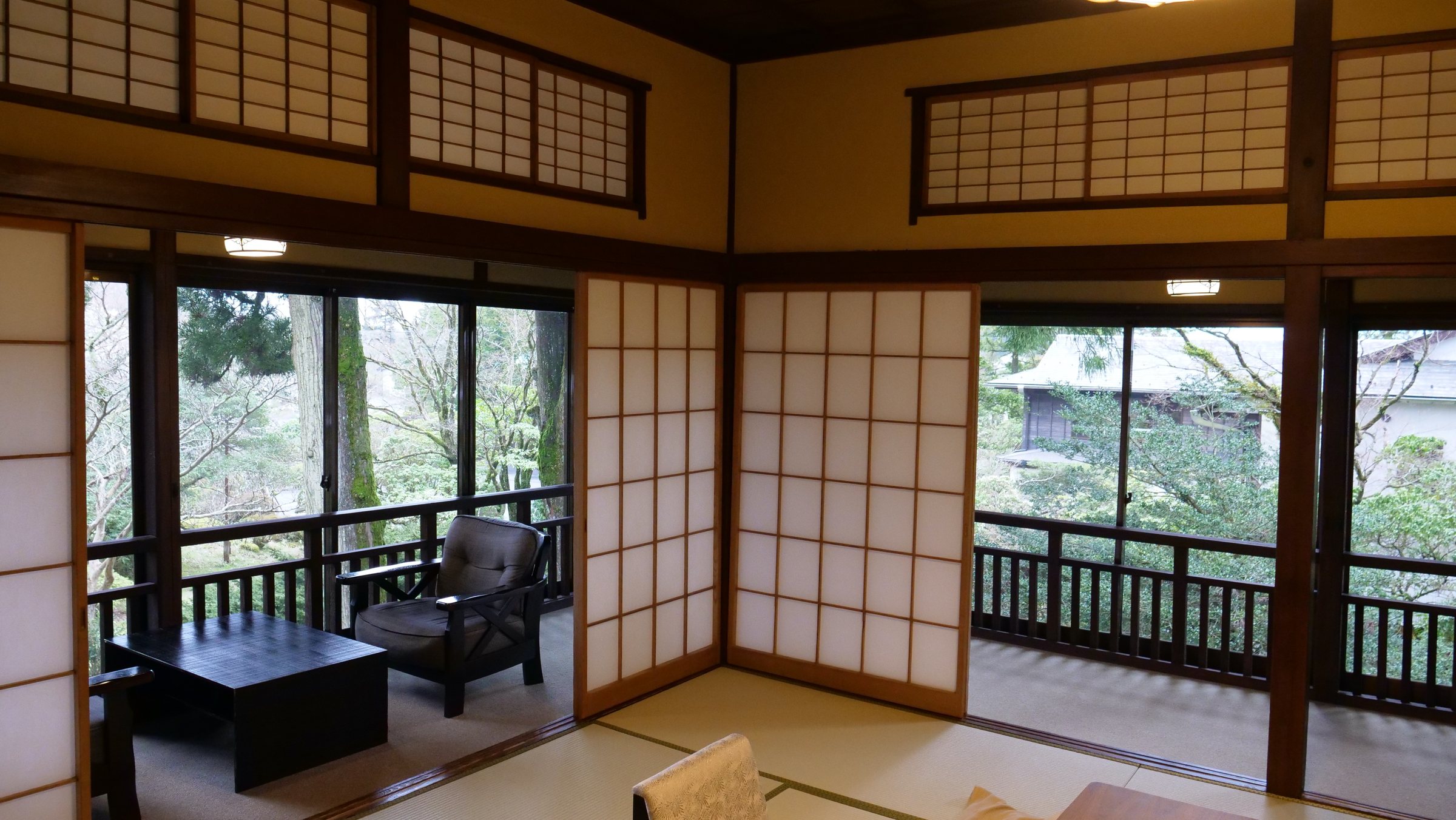 The room: shoji screens open on to a glassed-in veranda and the garden.