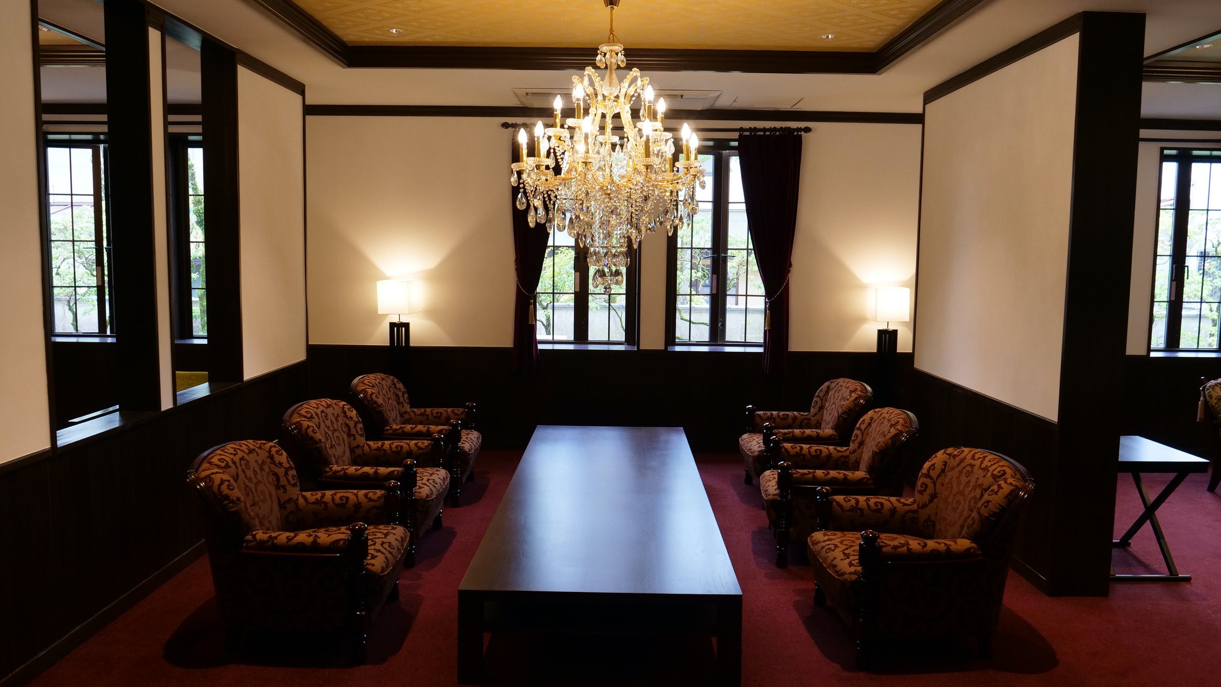 The lobby: a crystal chandelier, leopard-print armchairs and a deep red carpet.