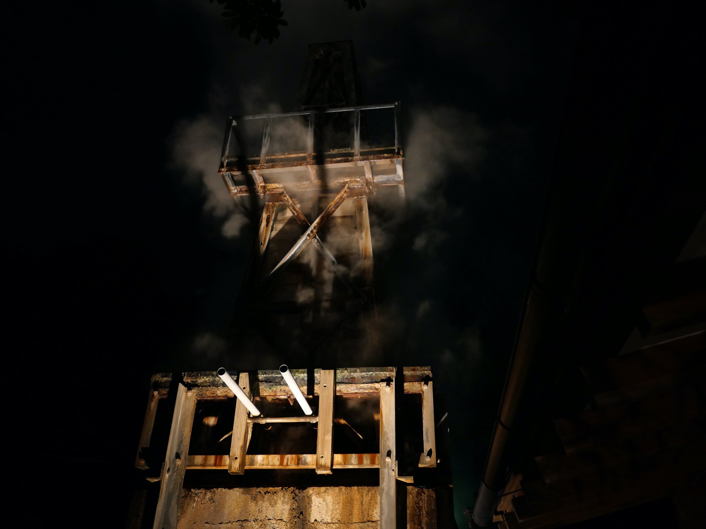 Steam rising from the source tower at night.