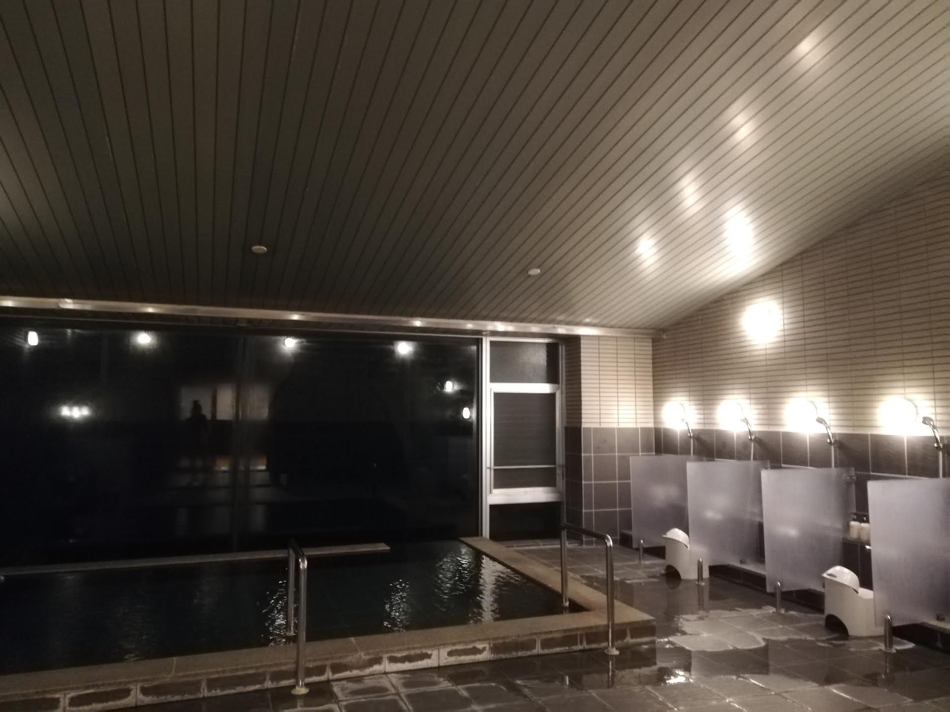 The communal bath, its tall windows facing the sea.