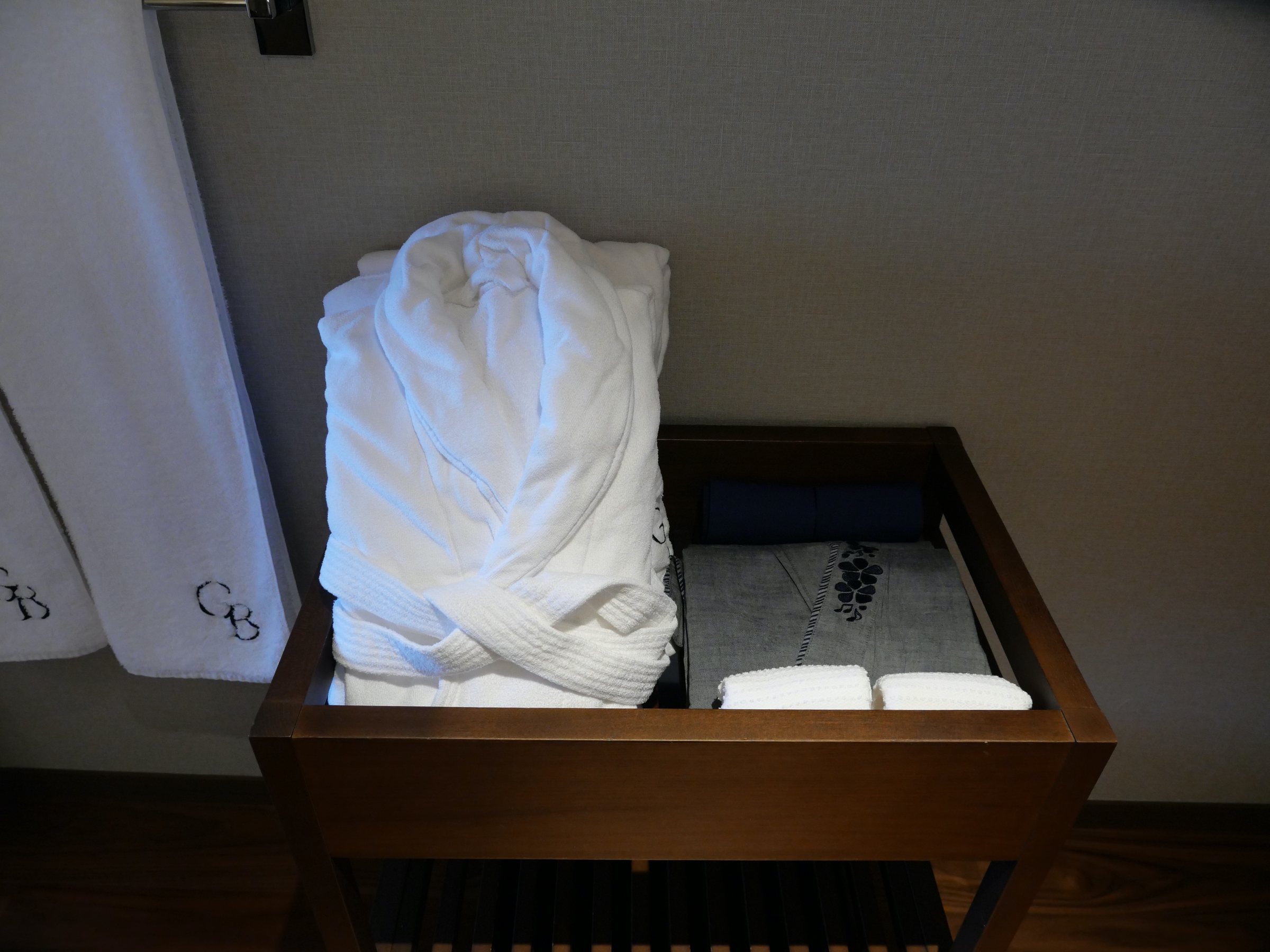Bathrobes and loungewear, folded and waiting.