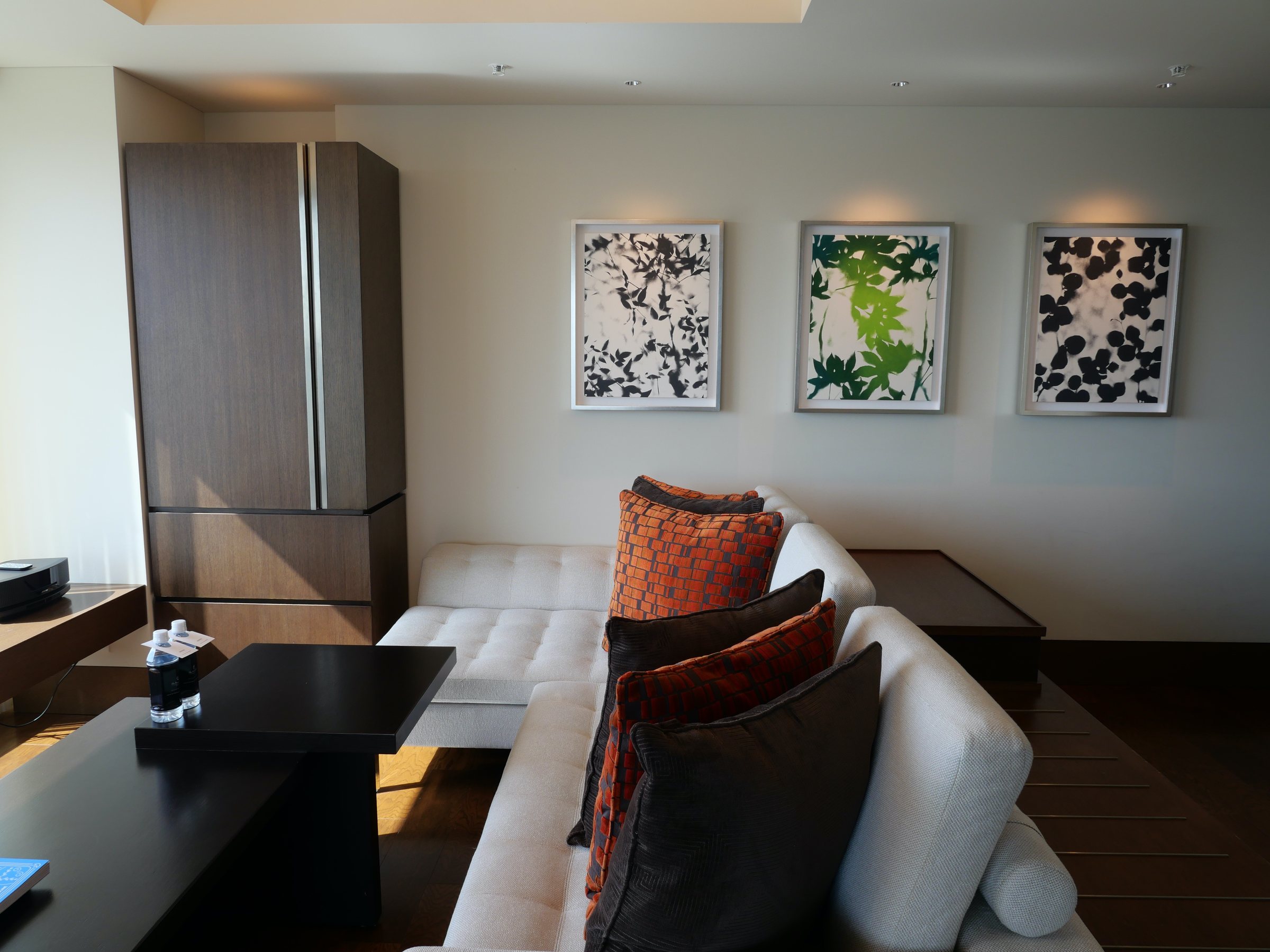A sofa and botanical prints.