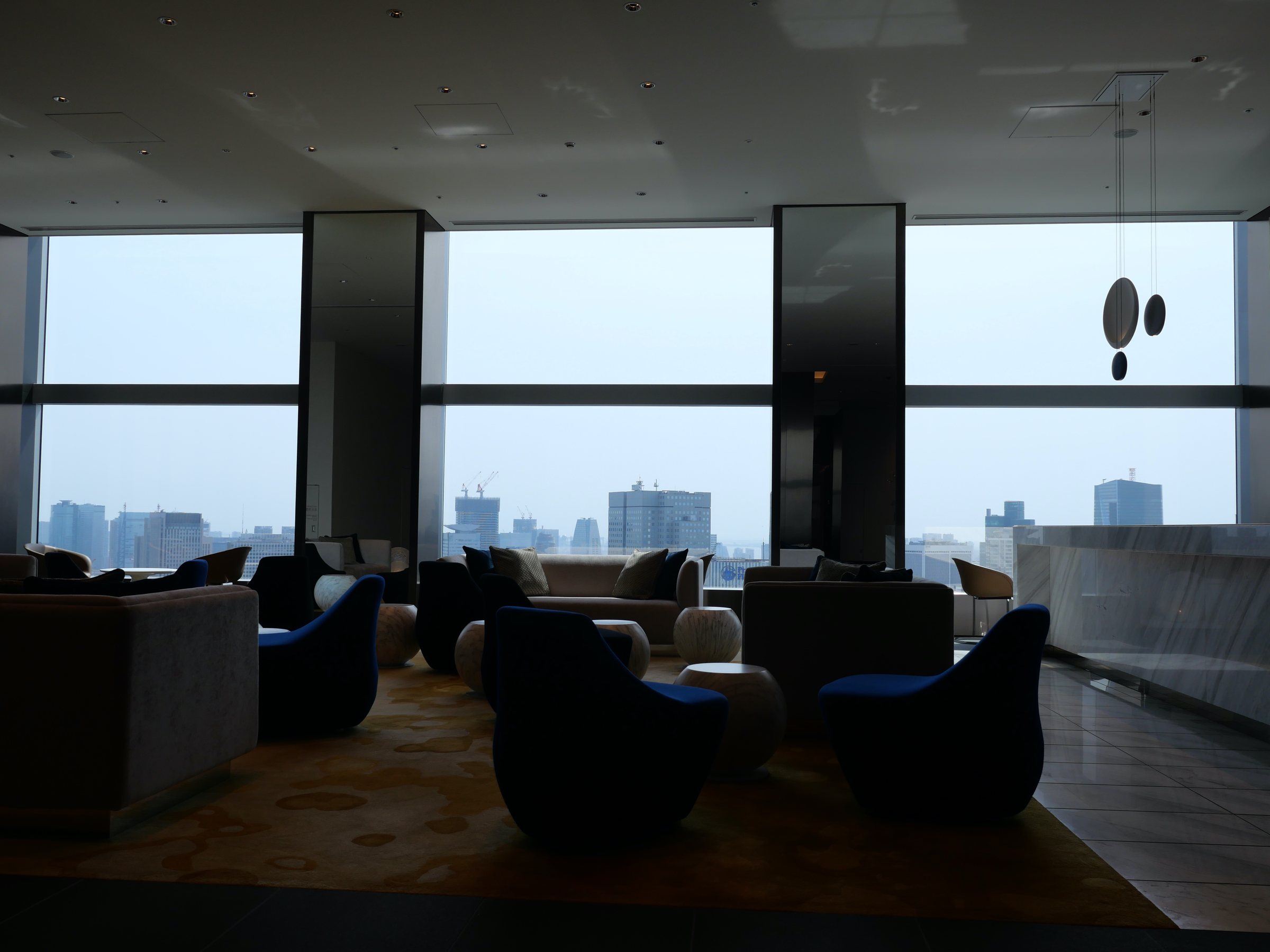Deep armchairs facing the glass.