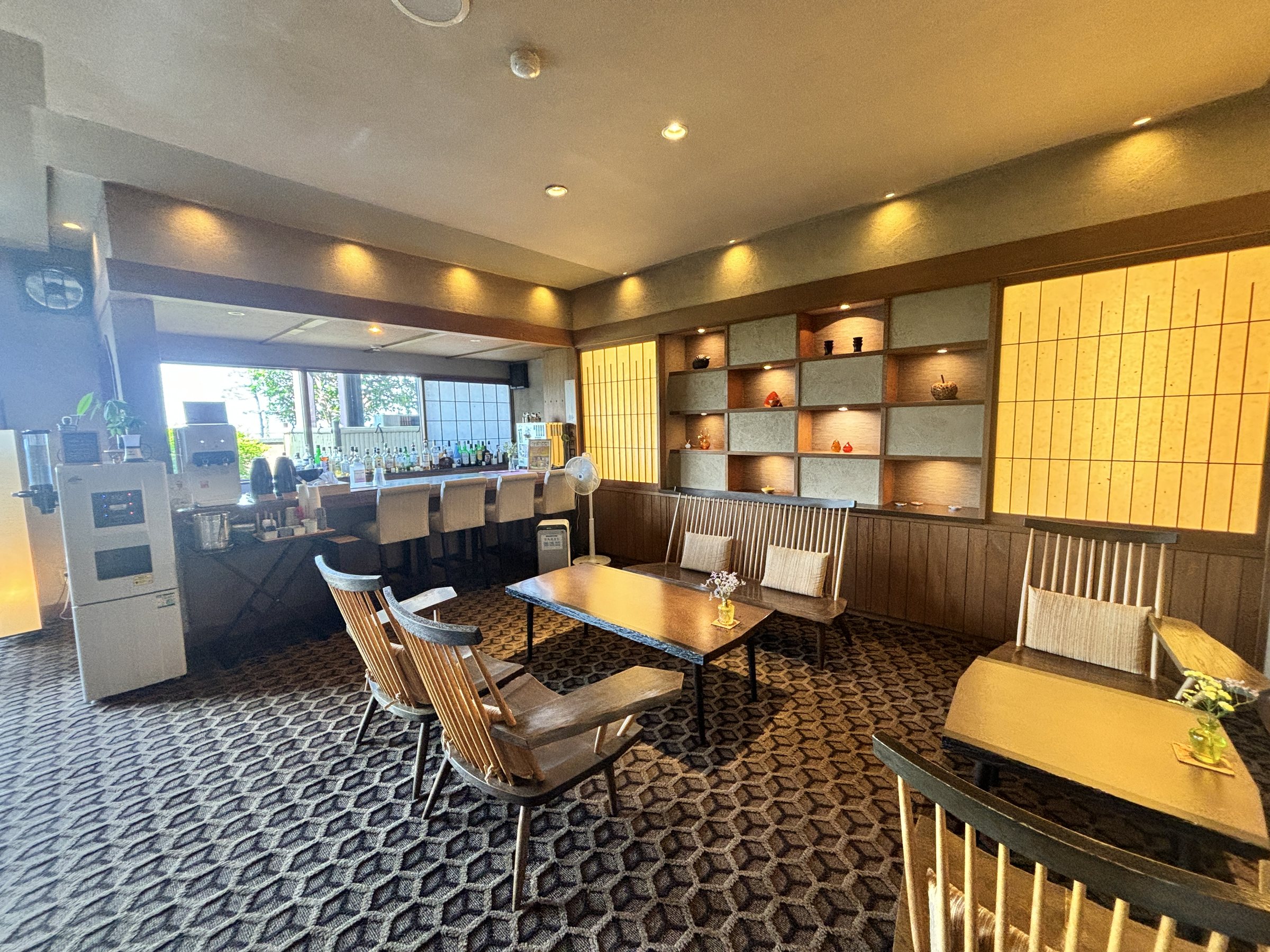 The bar counter and lounge, lit through shoji screens.