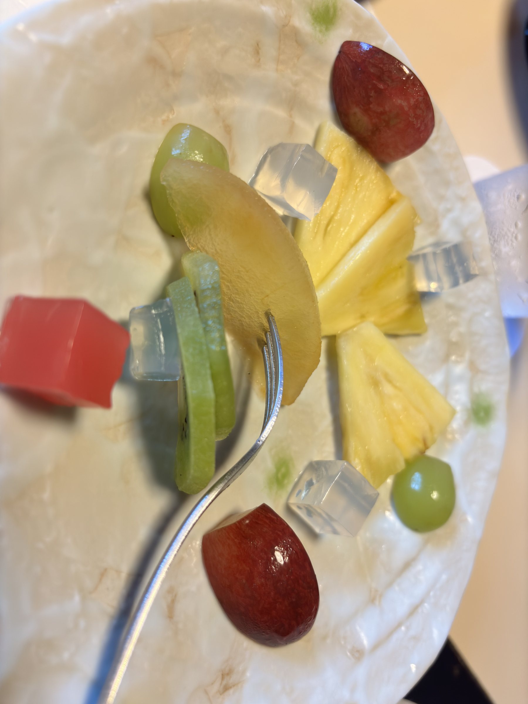Fruit and cubes of clear jelly.