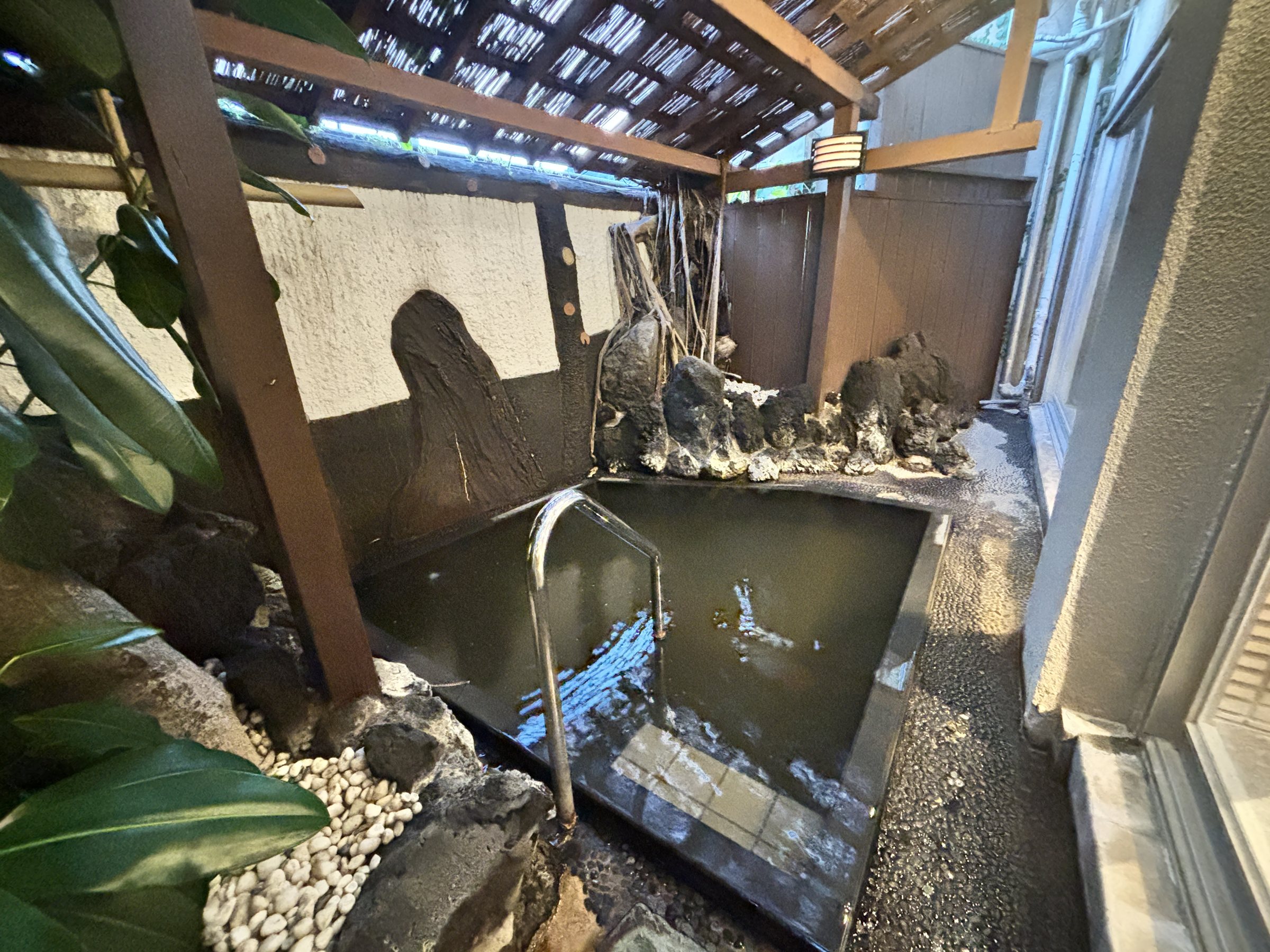 The private open-air bath, edged with rocks.