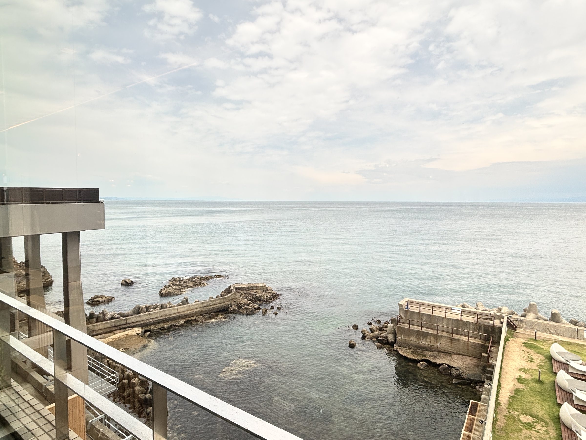 The breakwater and the open water of Osaka Bay below the balcony.