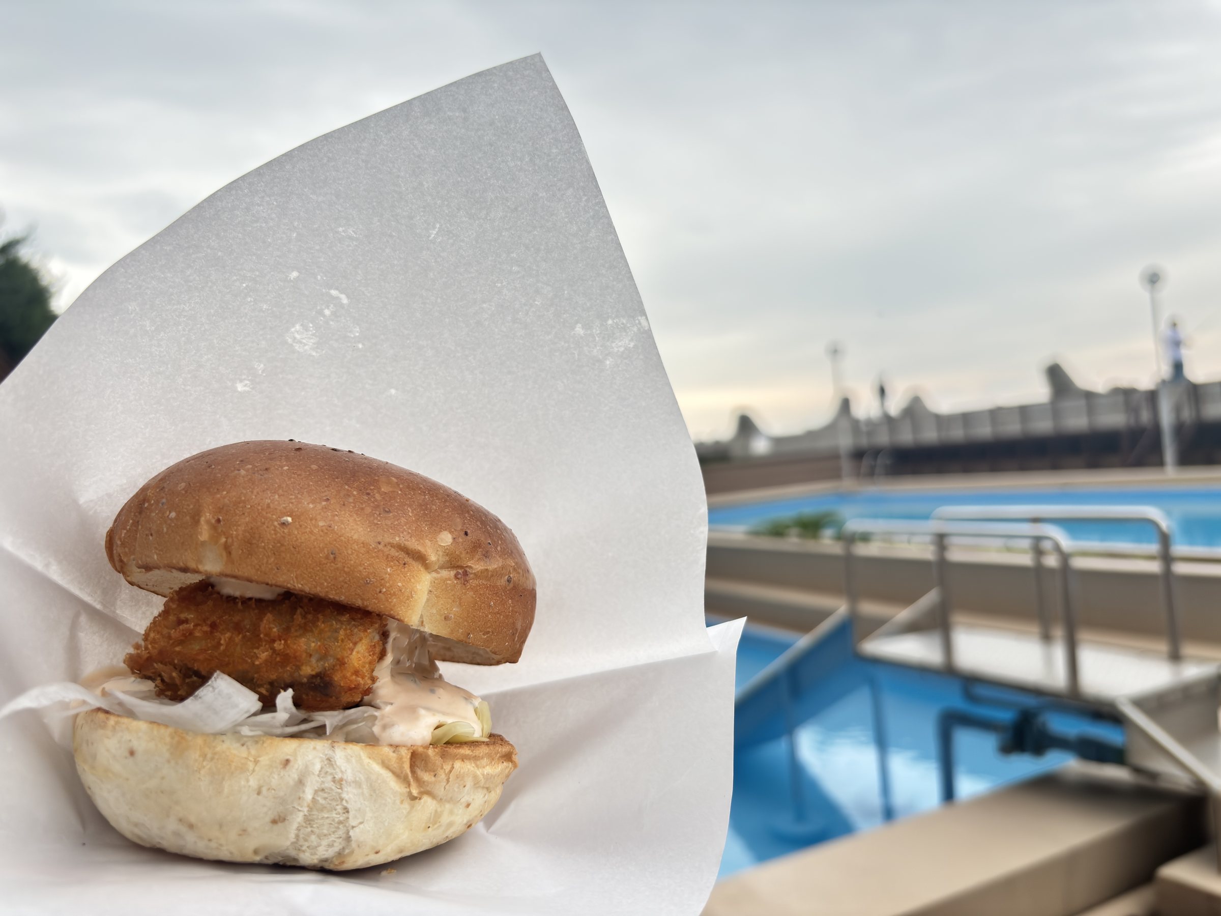 The sawara cutlet burger, eaten by the pool.
