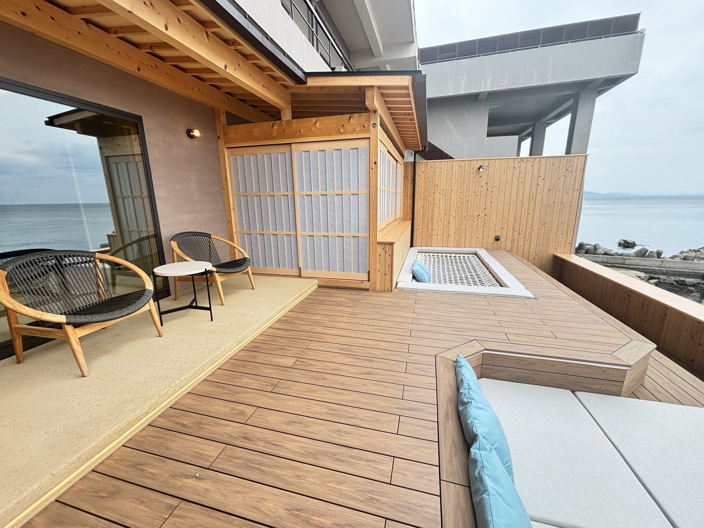 The other end of the balcony, with chairs and a fire table.