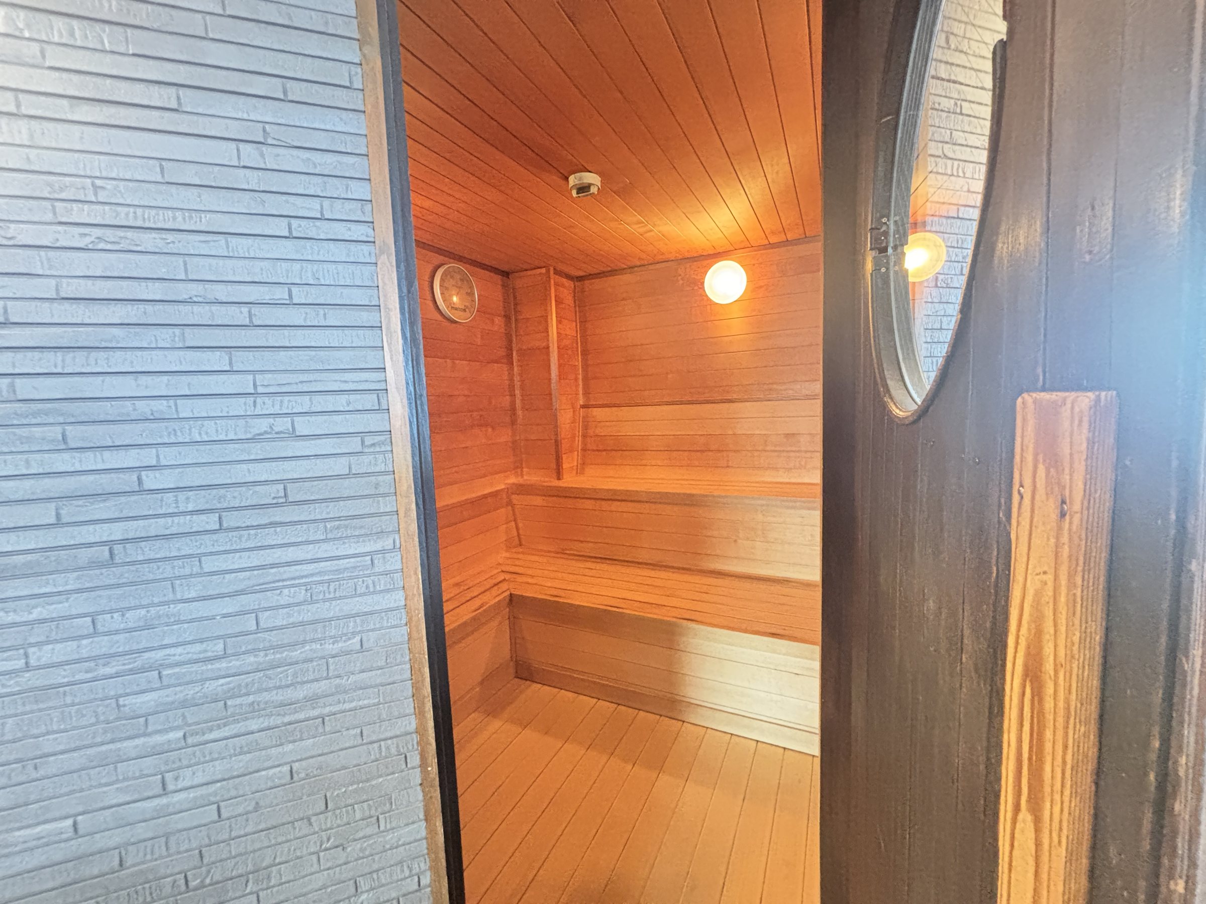 The sauna, lined in pale wood.