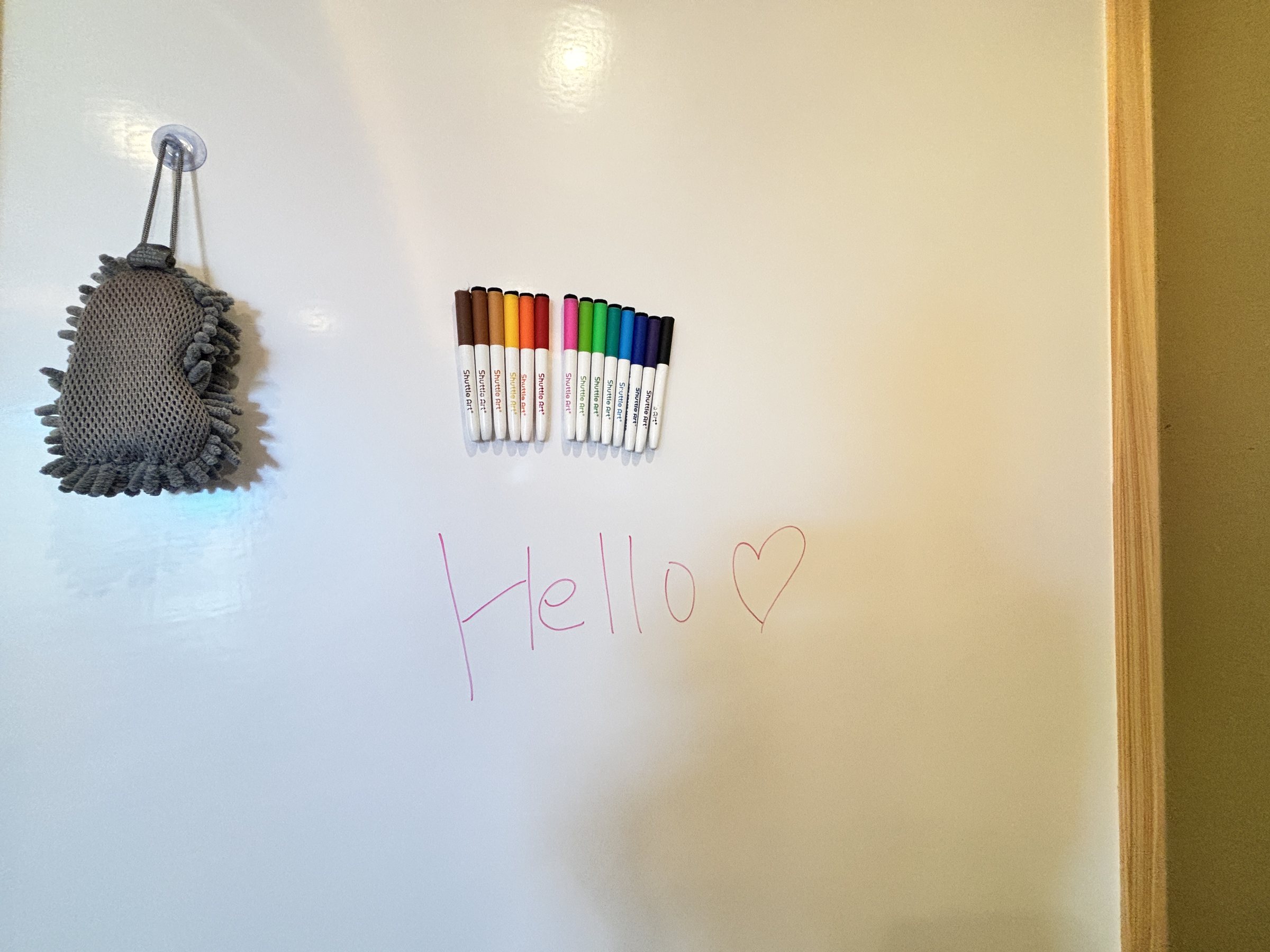 A whiteboard wall with marker pens.