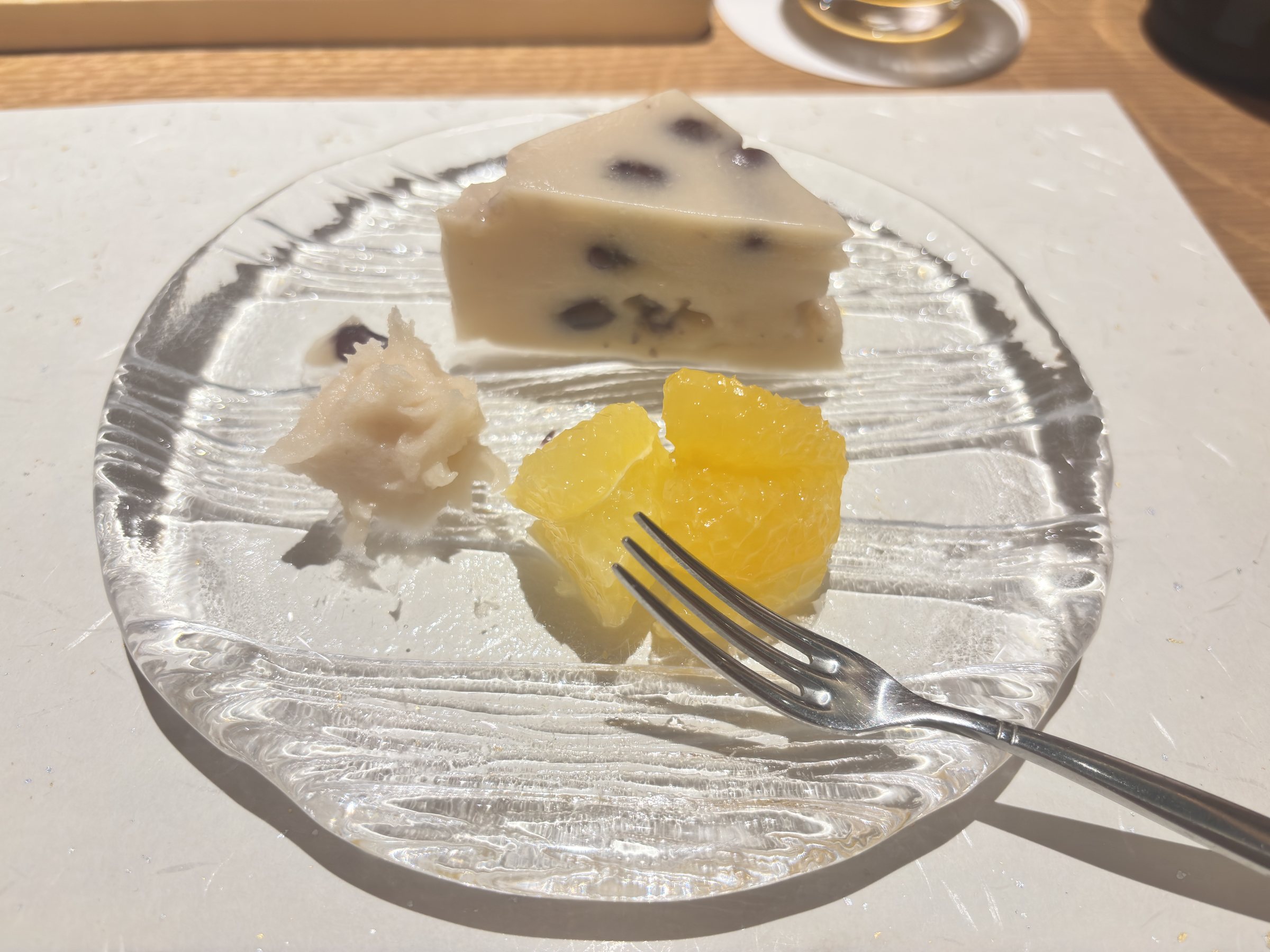 Dessert: a bean-studded sweet and orange jelly on a glass plate.