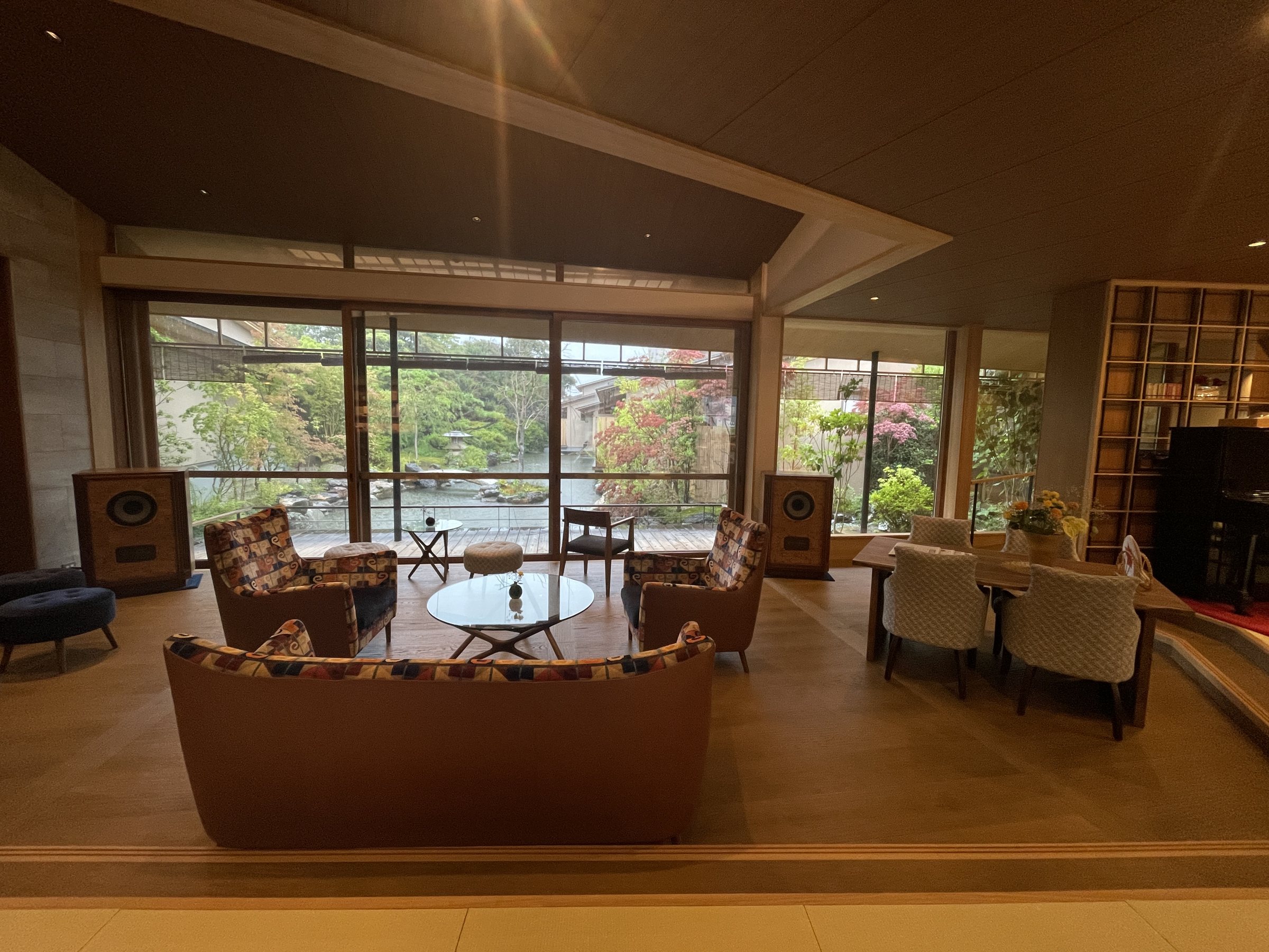 The lounge, with sofas and armchairs facing a wall of glass onto the garden.