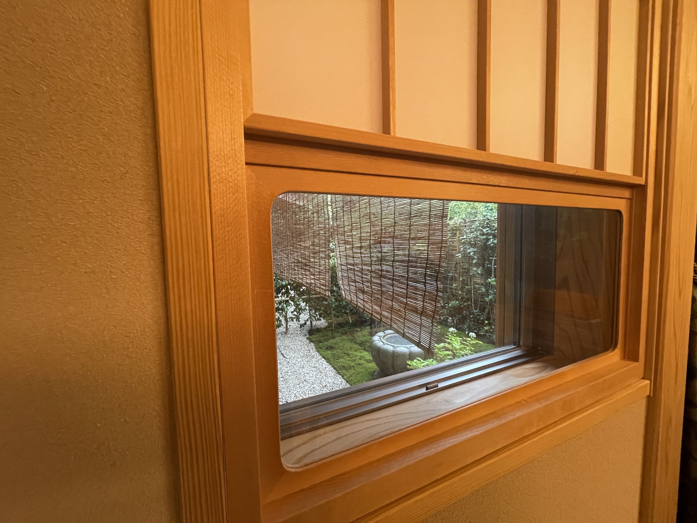 A small window framing a corner of the garden.
