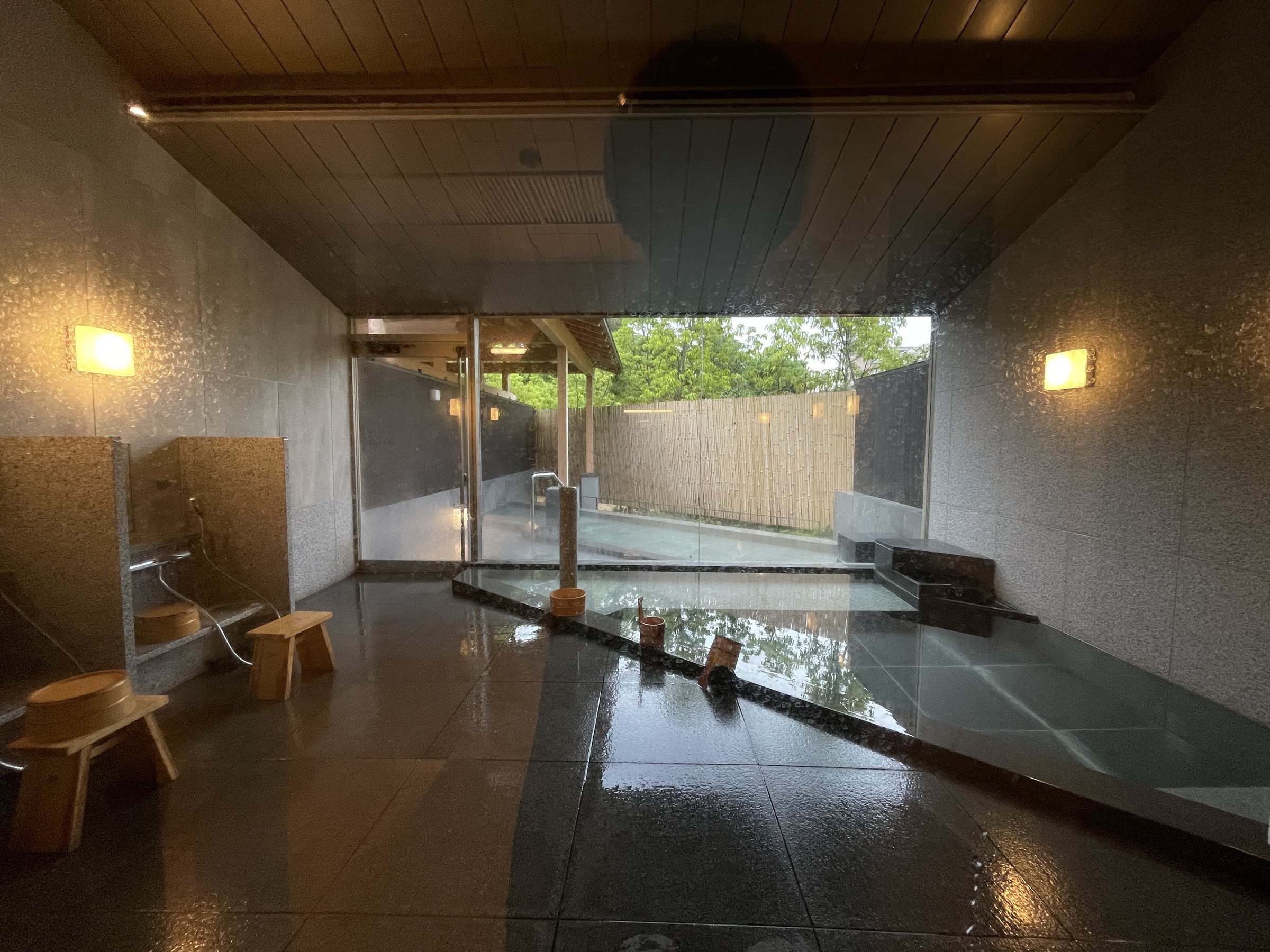 The indoor bath, opening onto the outdoor bath beyond.