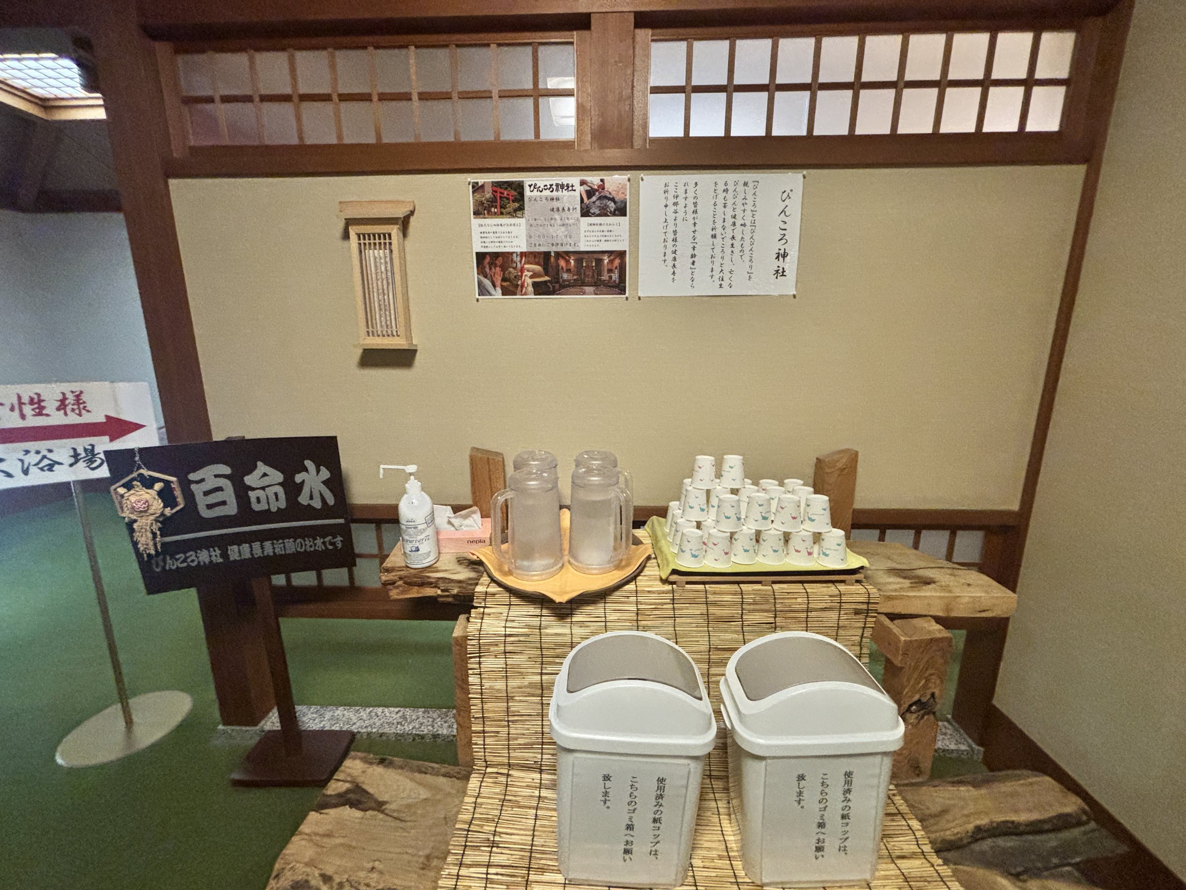 The Hyakumeisui water station, with cups set out beneath a small shrine shelf.