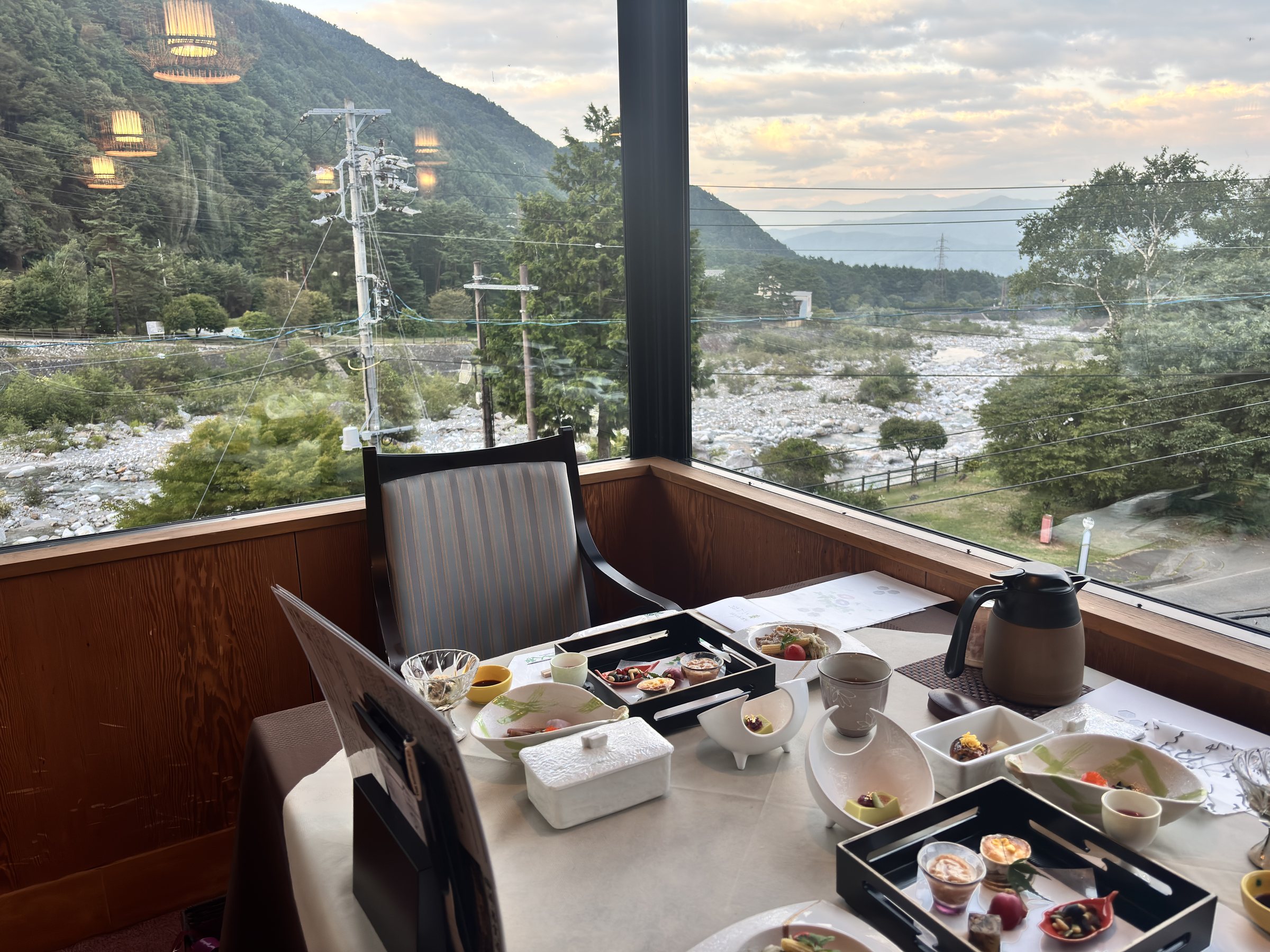 A table by the window, with the river valley and mountains beyond.