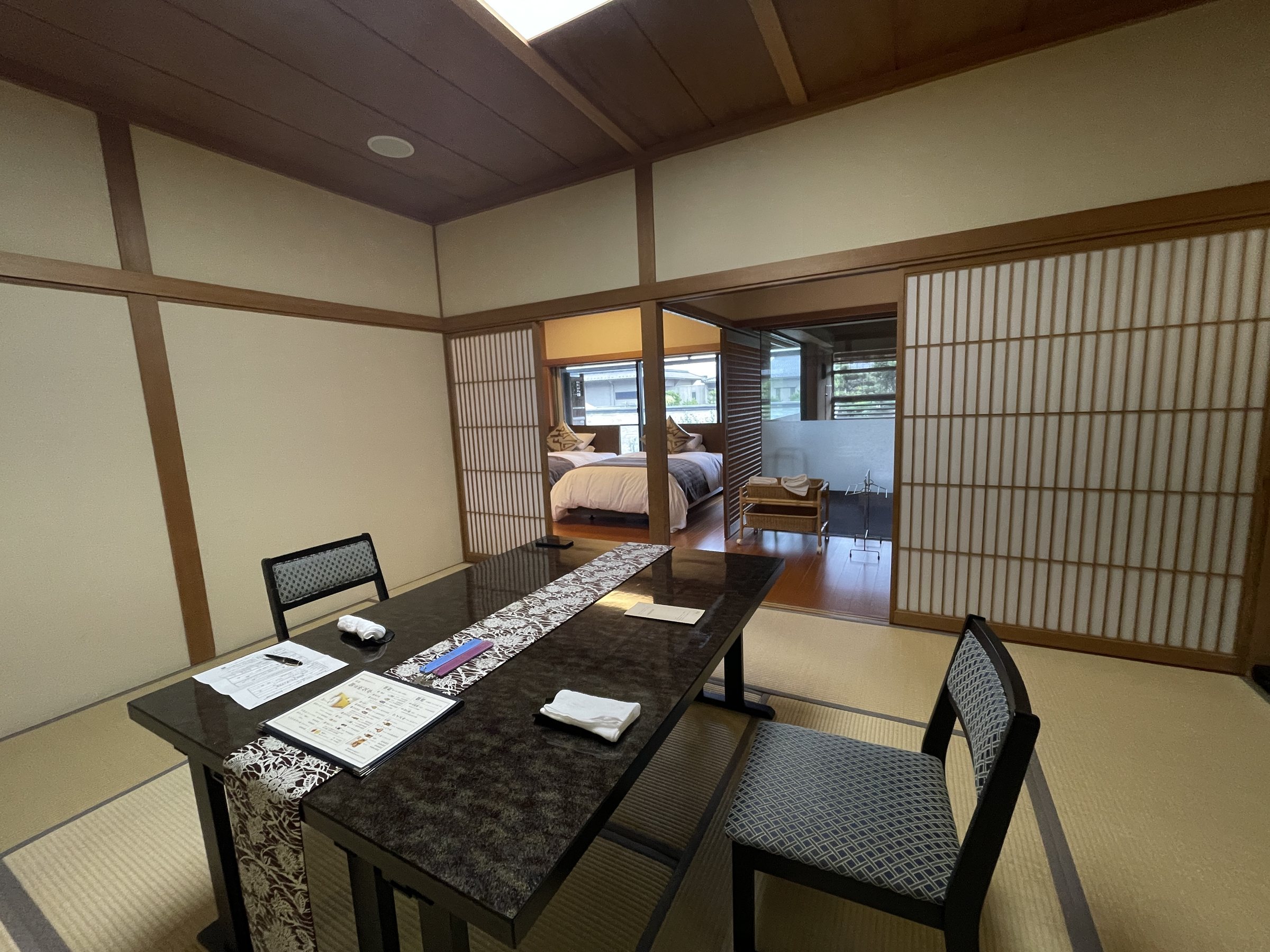 The tatami sitting room, with a lacquered table and chairs.