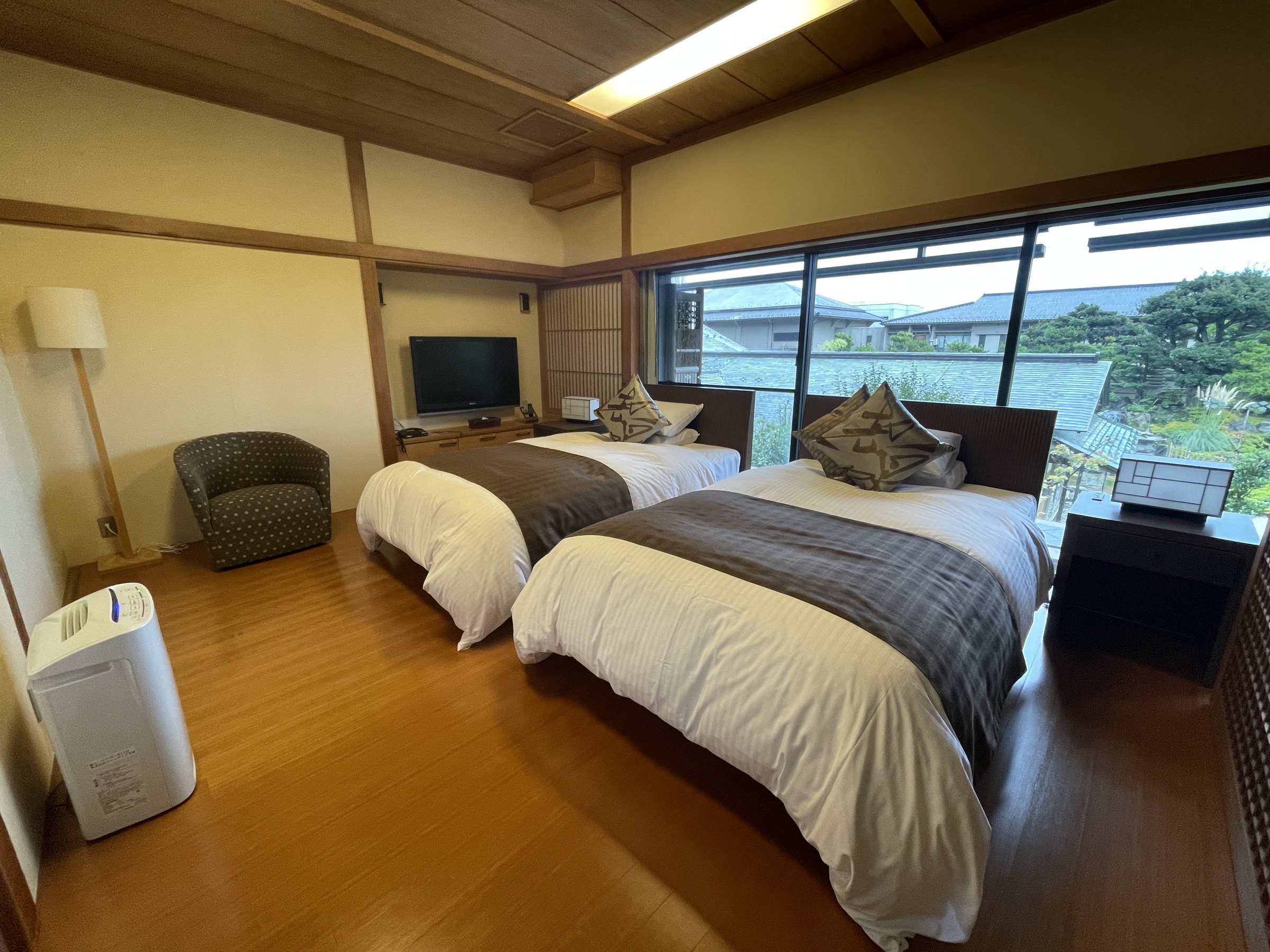 The bedroom, with twin beds and a wall of windows.