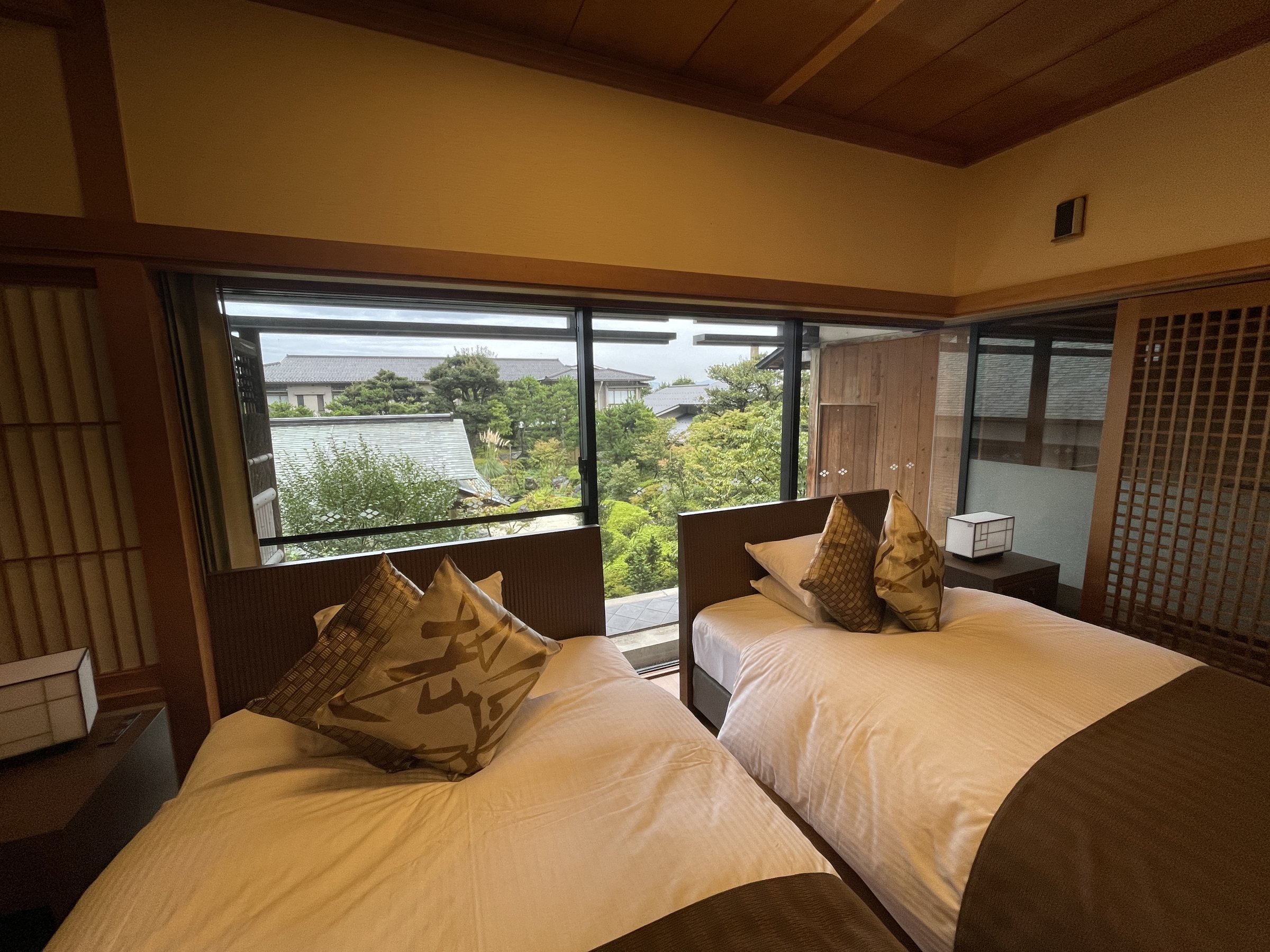 Neatly made beds facing the garden.
