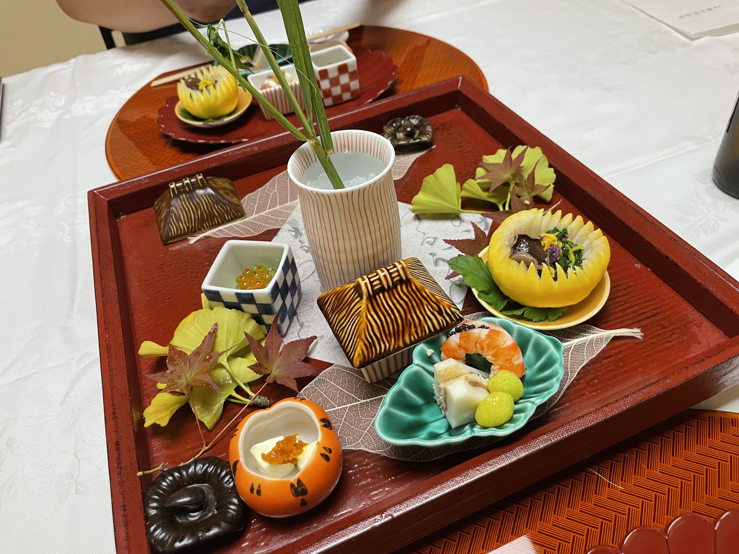 The hassun on a lacquered tray, decorated with autumn leaves.