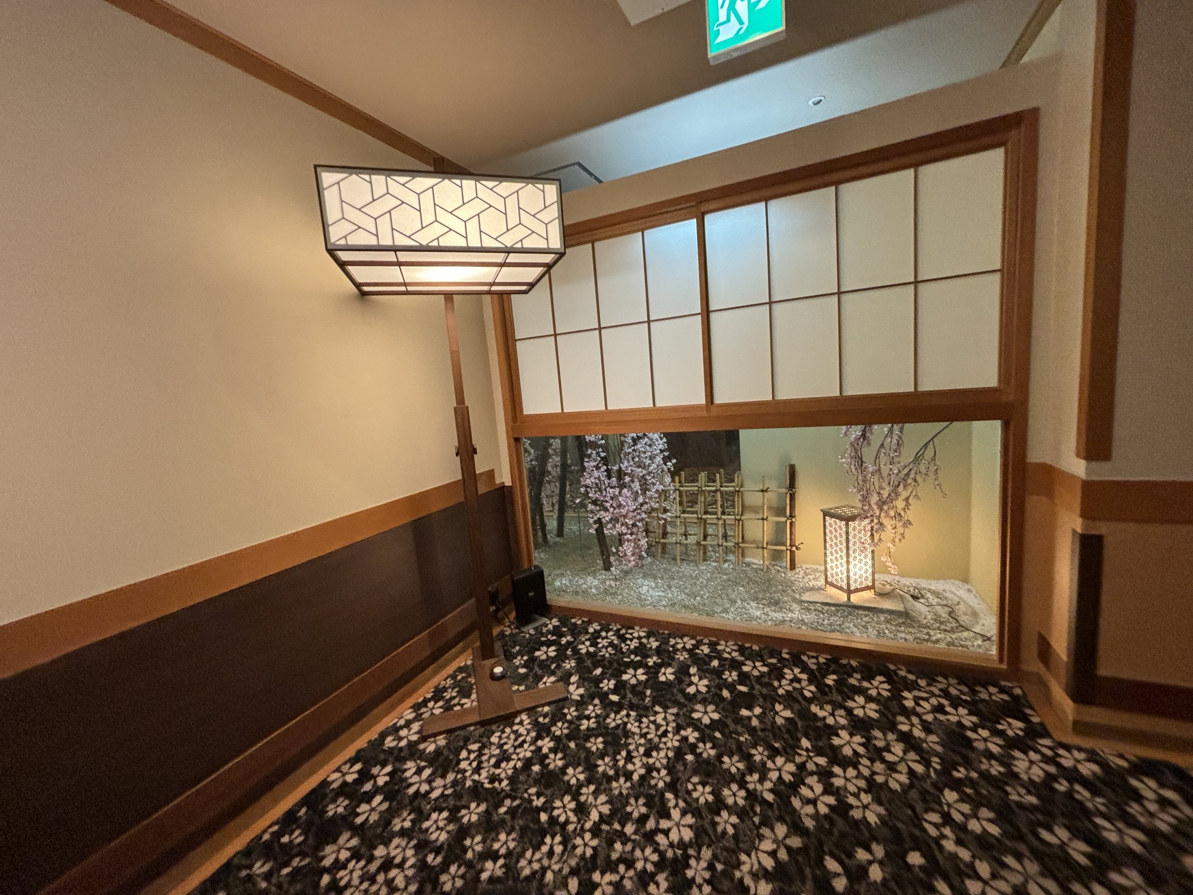 A decorative window and seasonal flowers on the way to the baths.