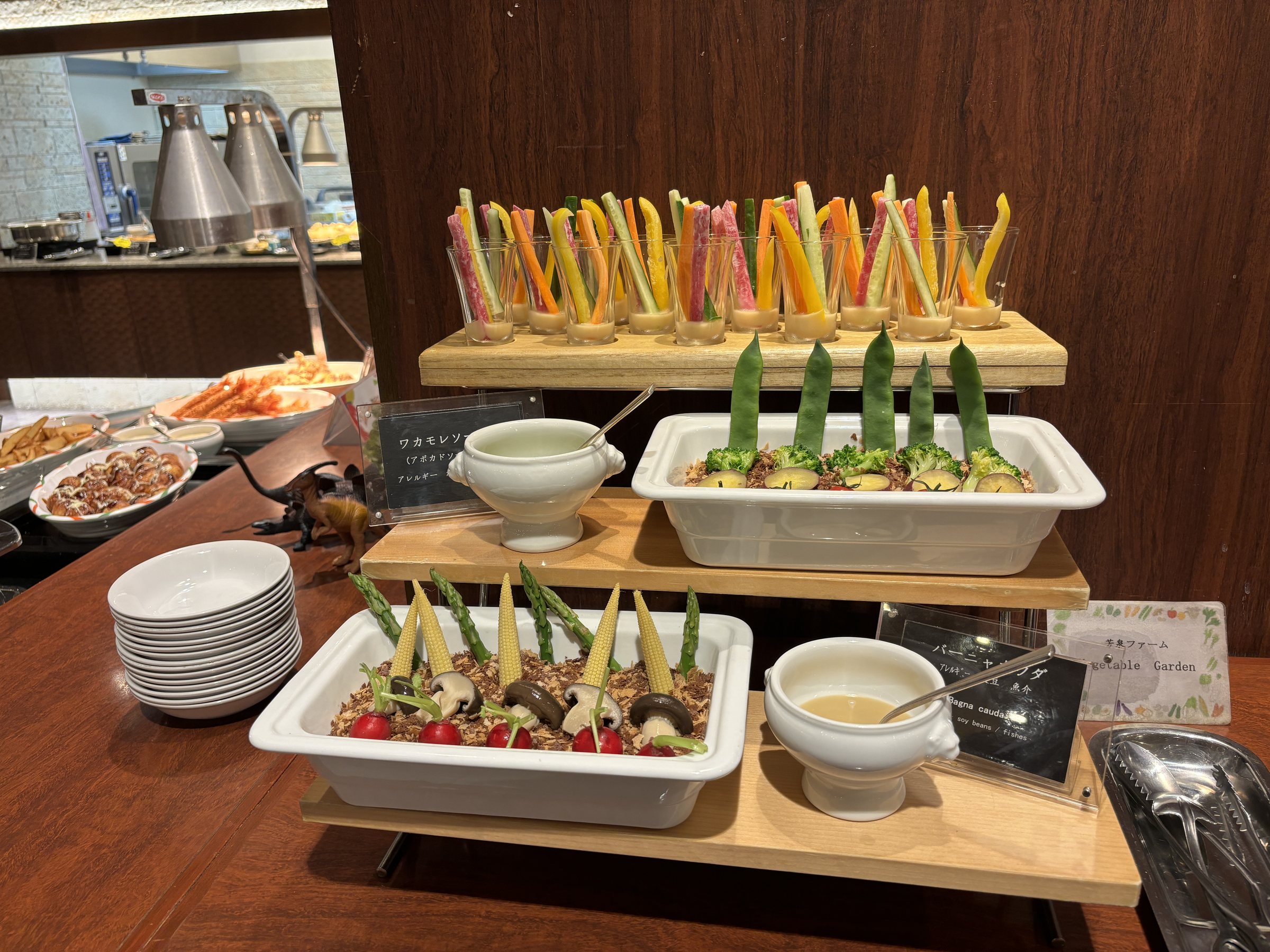 Vegetable sticks and salads on a tiered display.