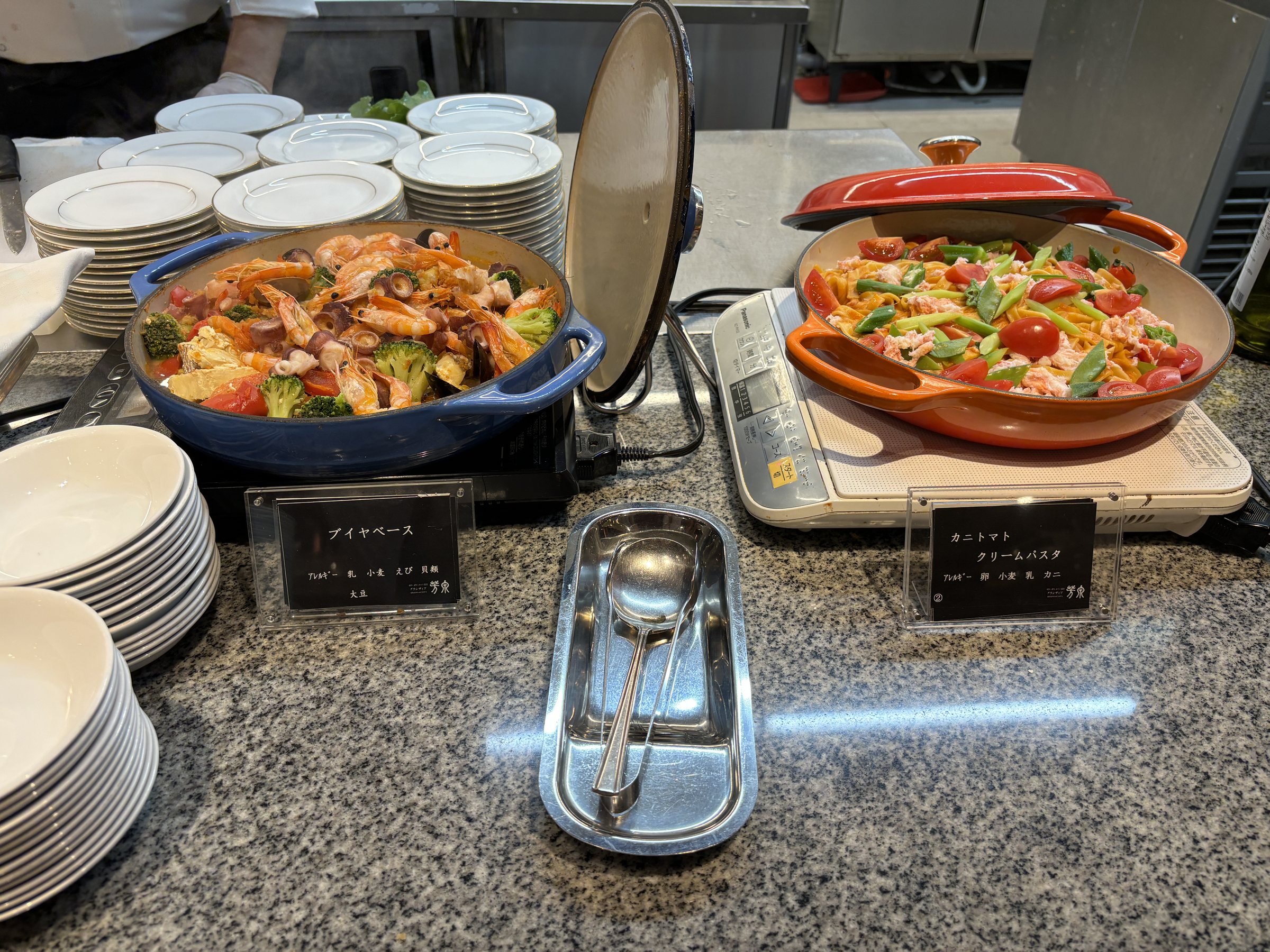 Rice dishes in colorful cast-iron pans.