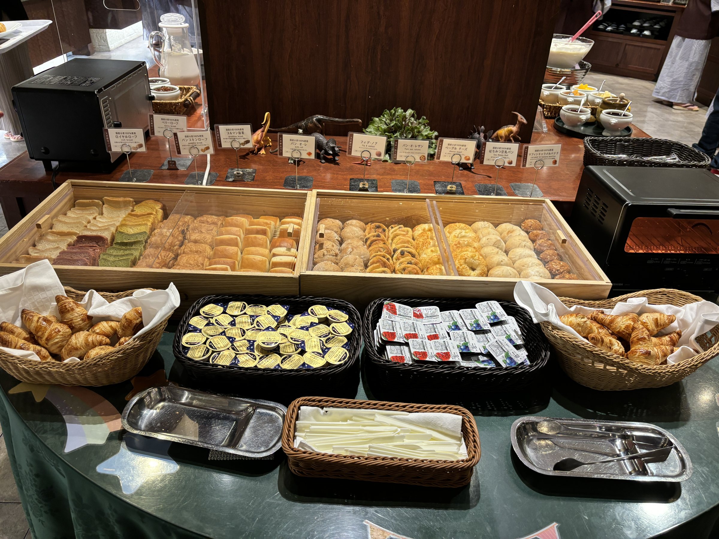 The bread corner, with baskets of mini rolls and pastries.