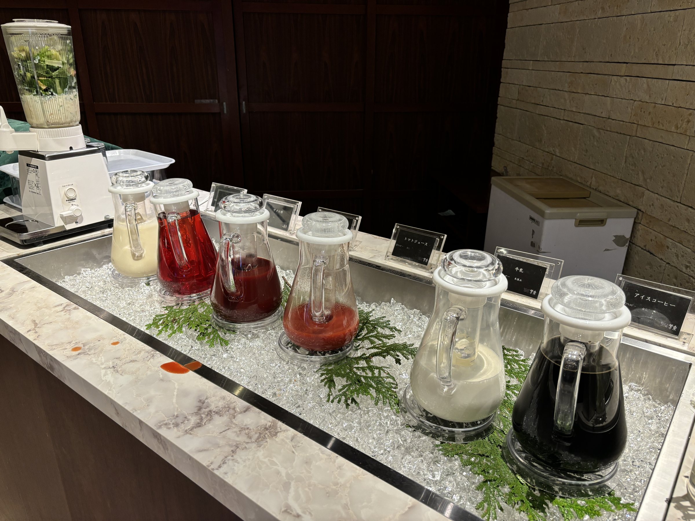 Jugs of juice and milk on ice.