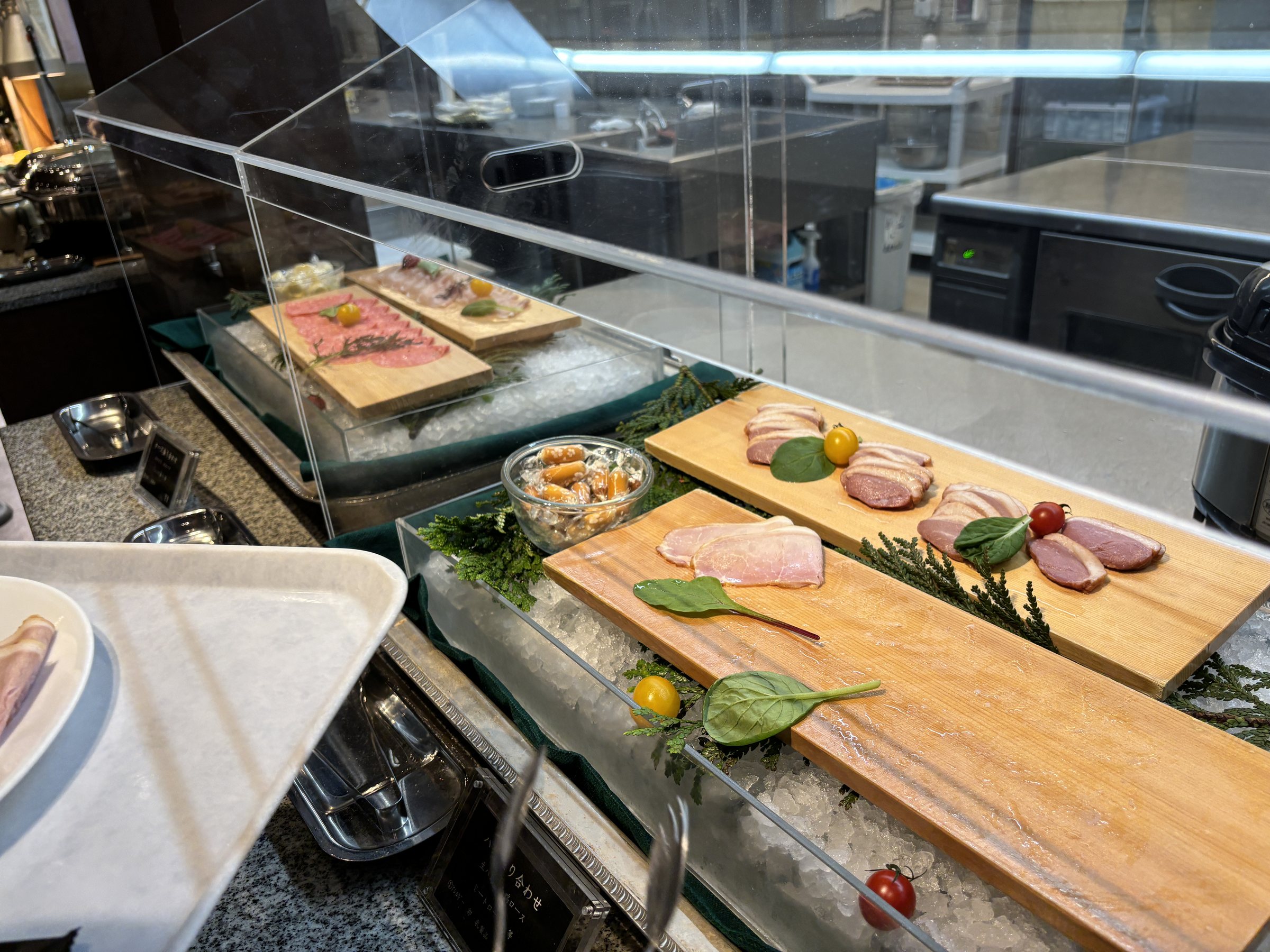 Ham and cured meats on wooden boards.
