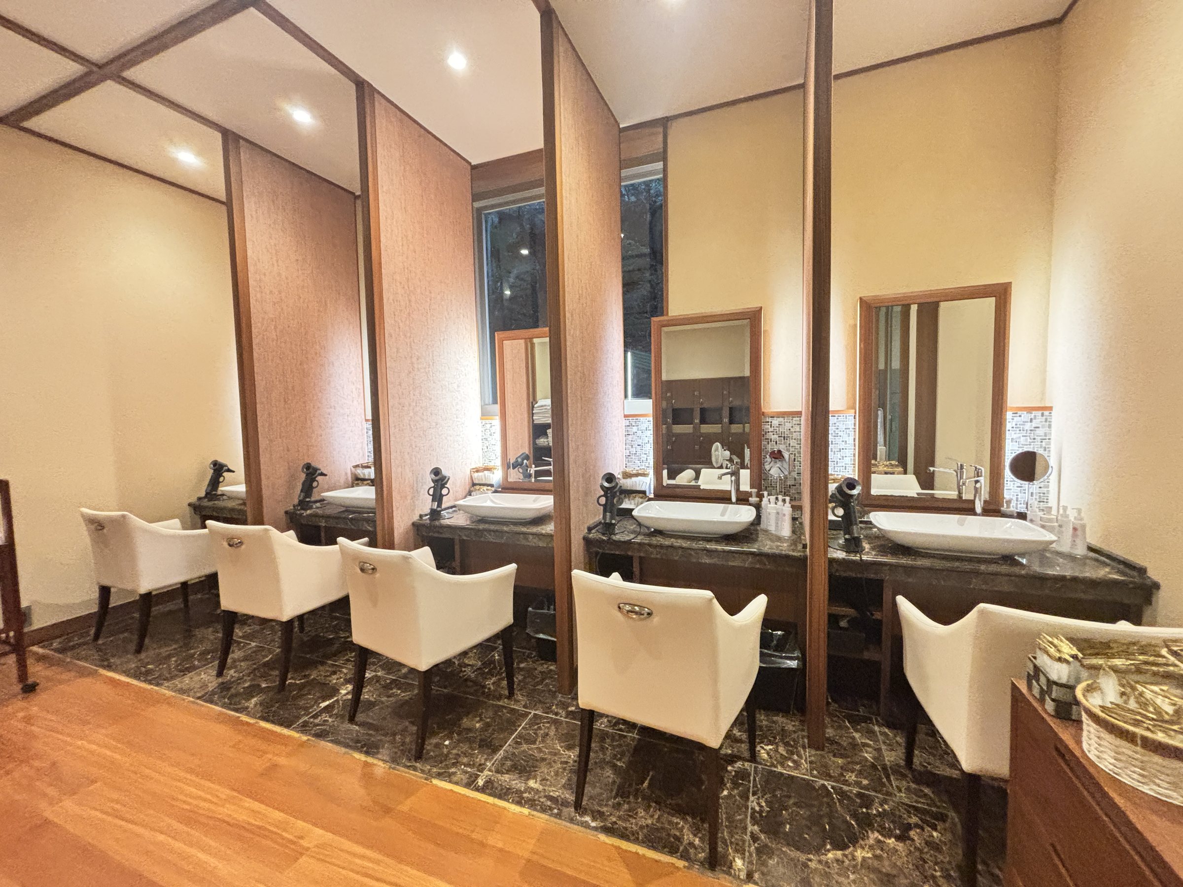 Individual vanity booths in the changing room, each with its own armchair.