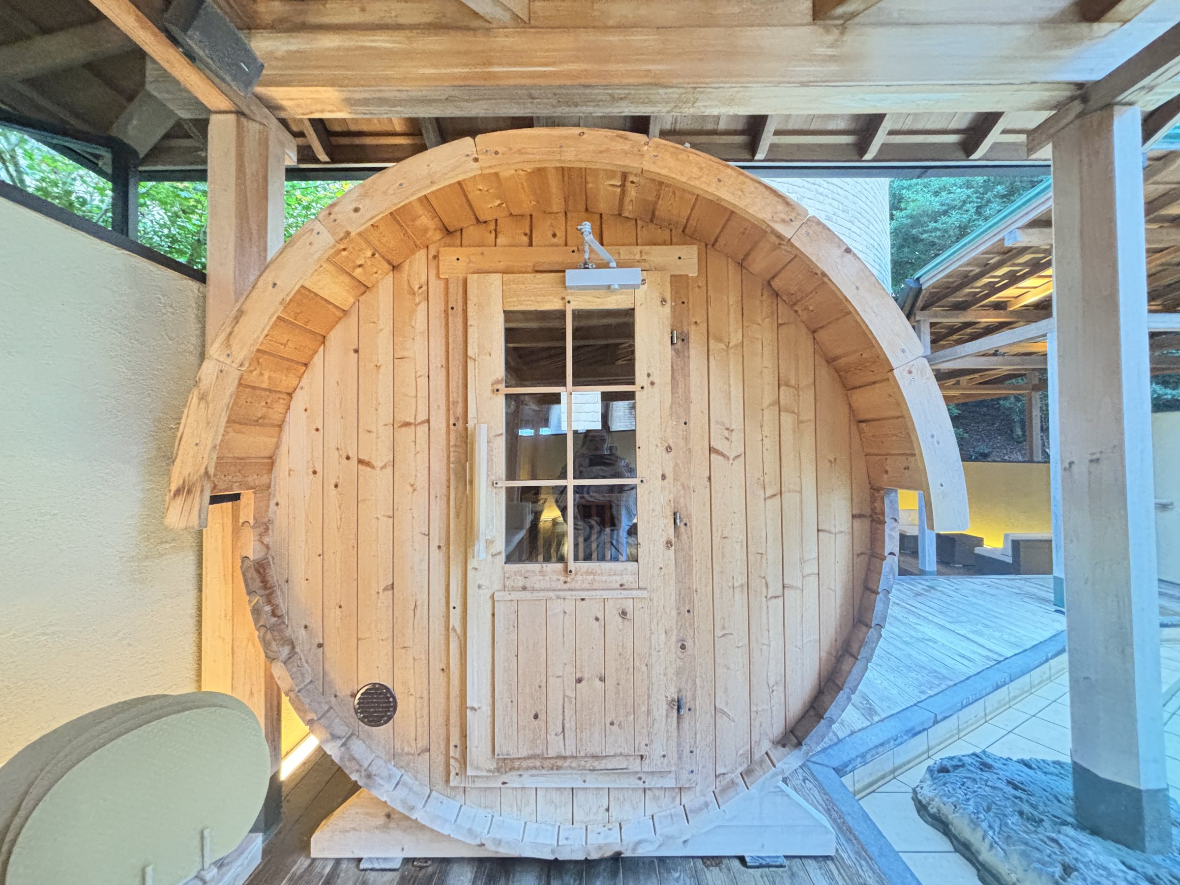 The barrel sauna on the wooden deck.