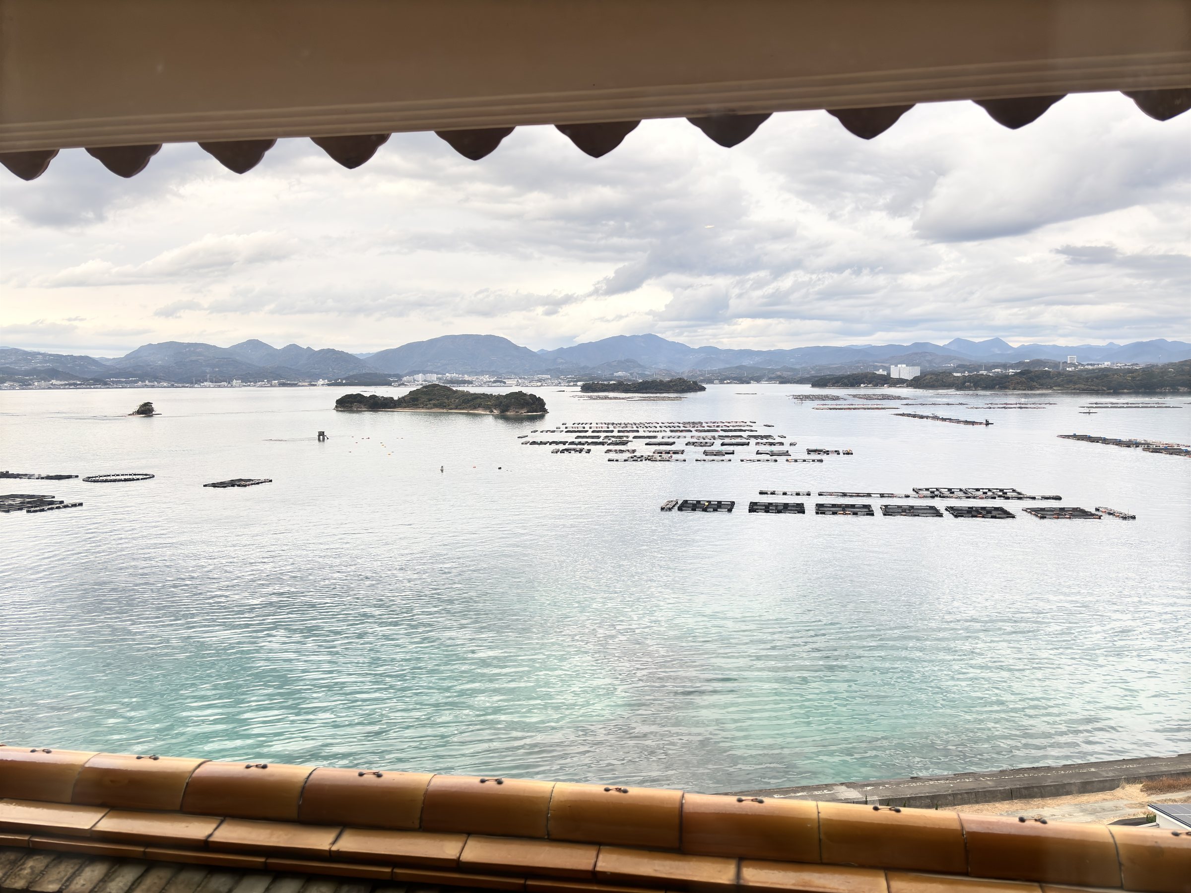 Tanabe Bay from the hotel, with aquaculture rafts and distant mountains.