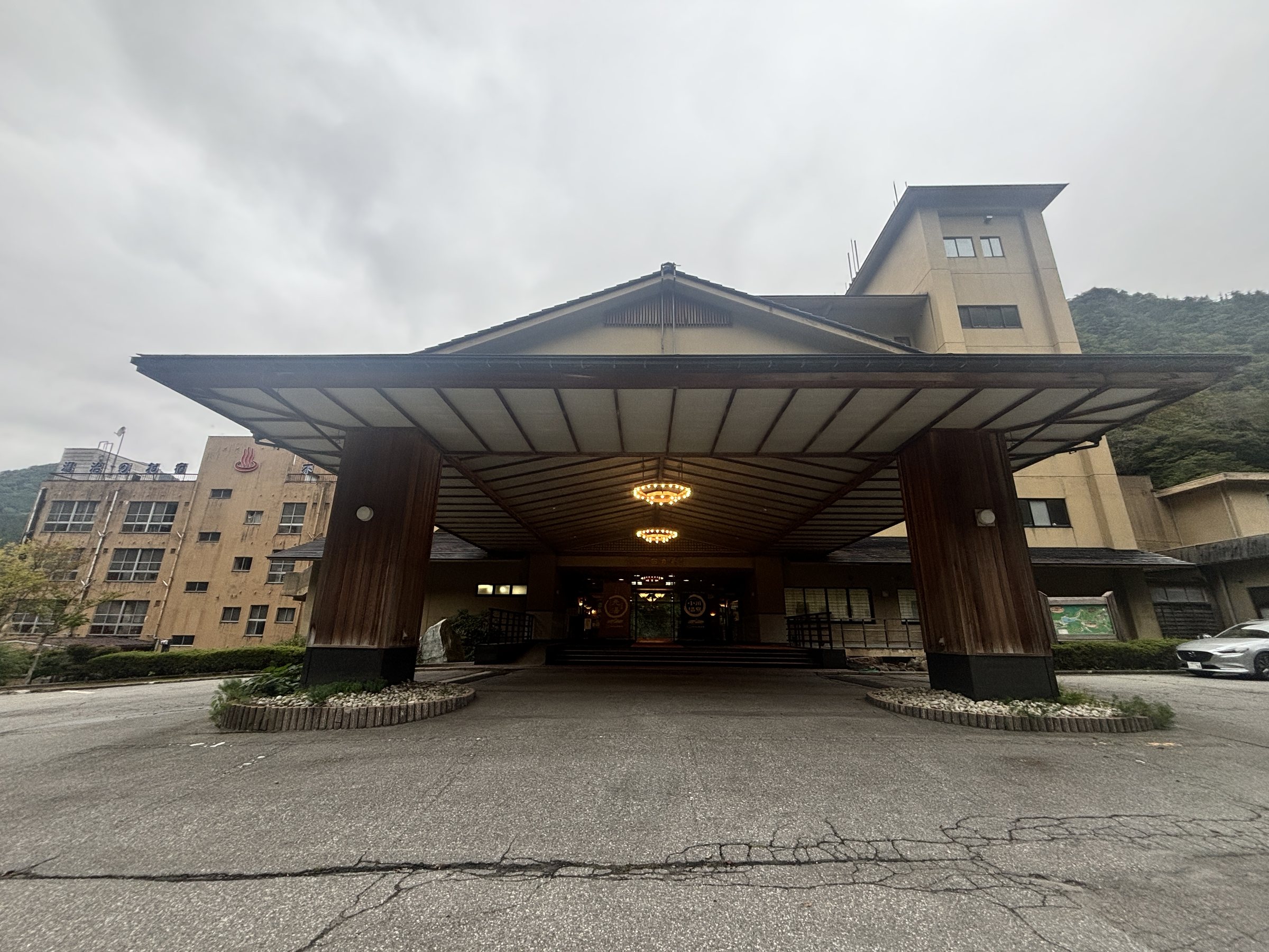 The hotel's porte-cochère, with the wooded valley behind.