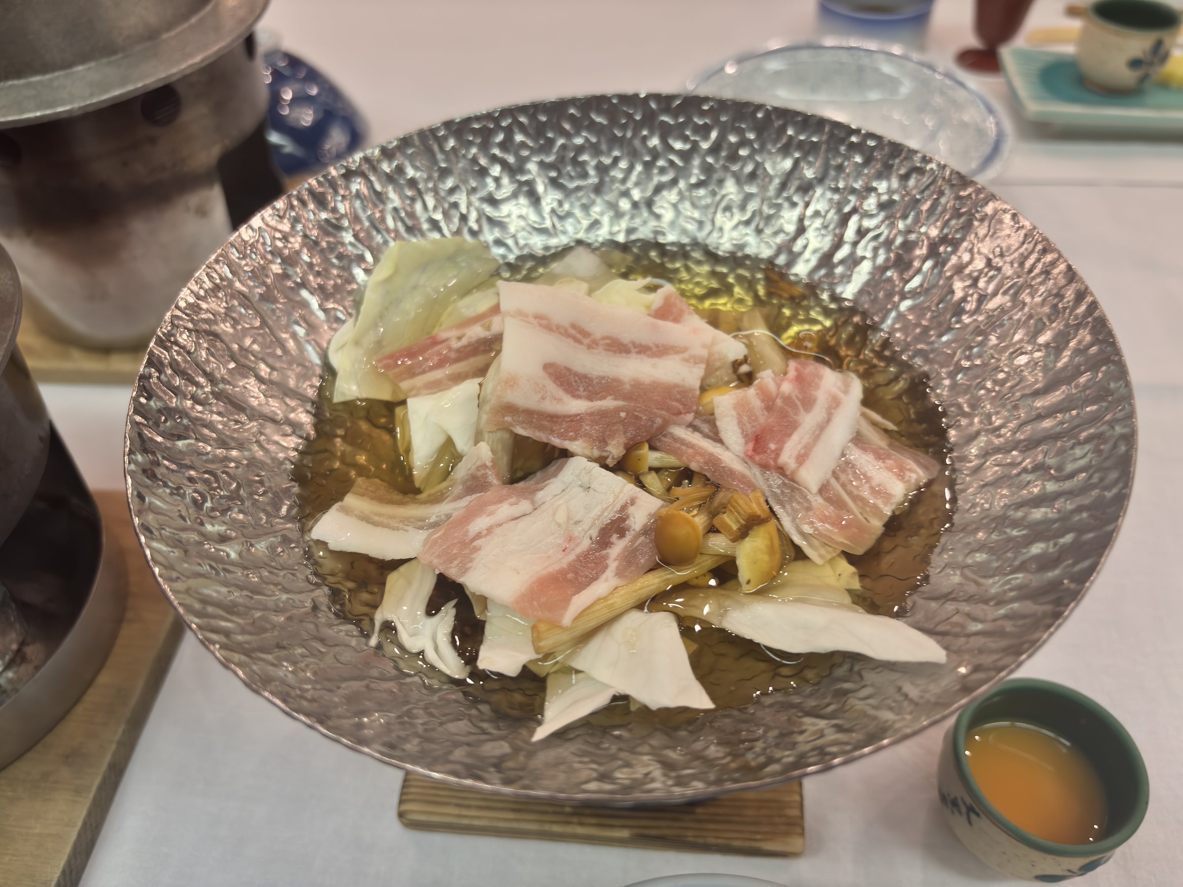 A hot pot of pork and vegetables.