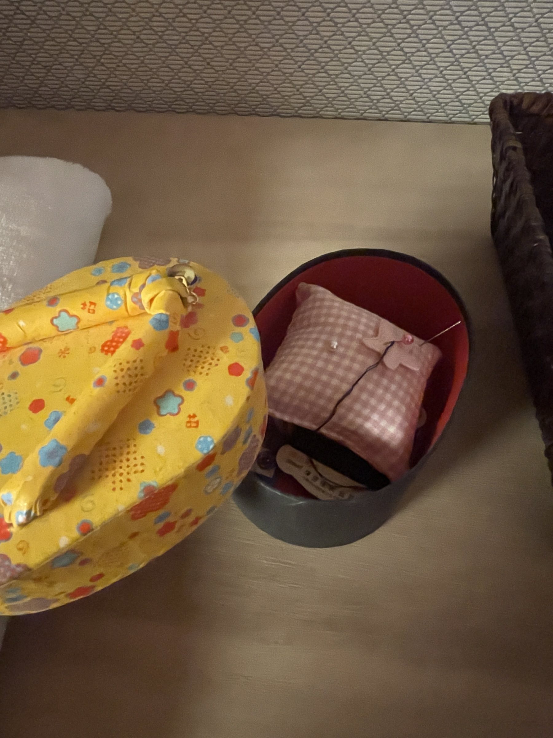A sewing kit in a patterned case, found behind the sliding door.