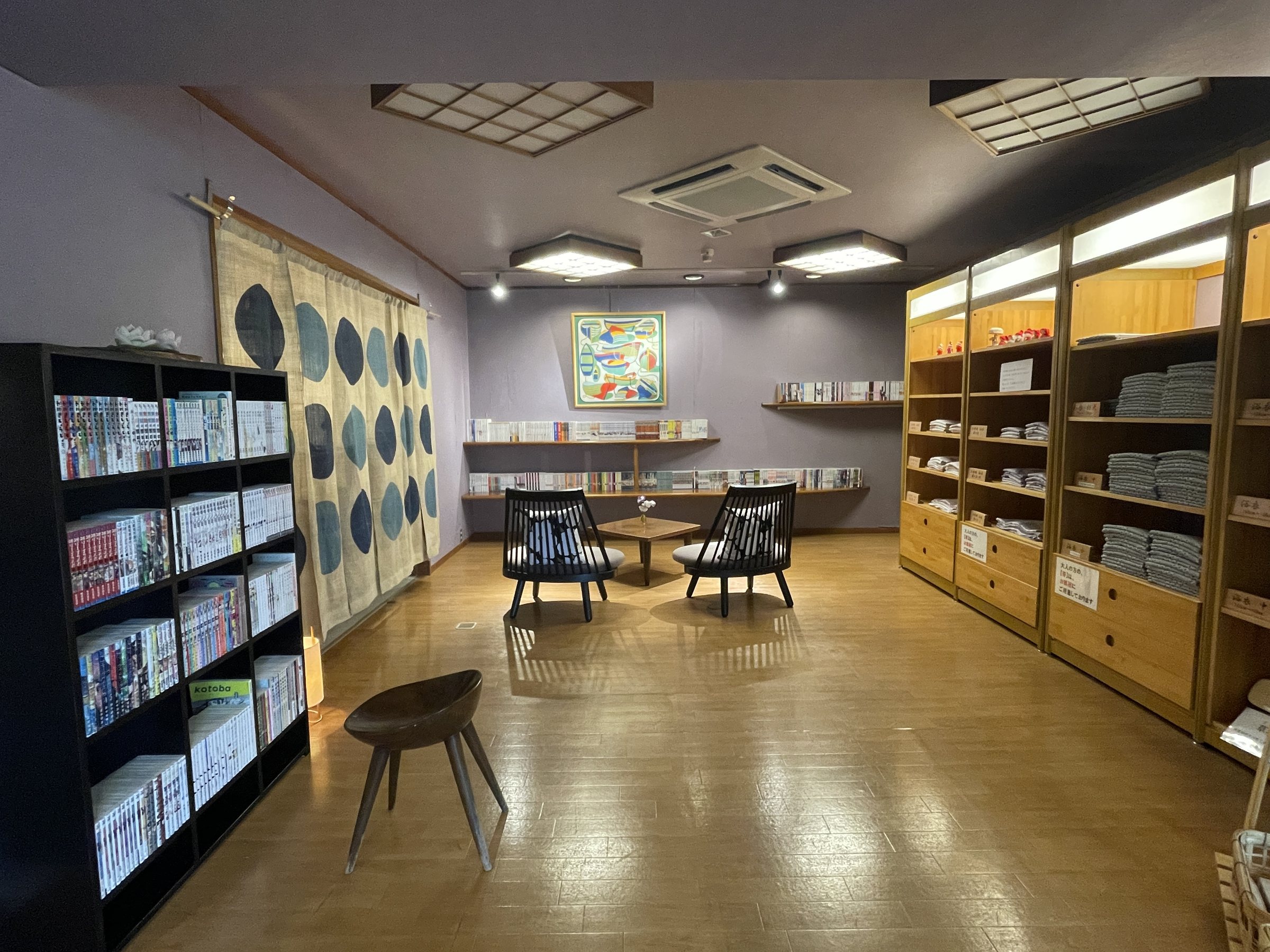 A quiet reading room with bookshelves and armchairs.