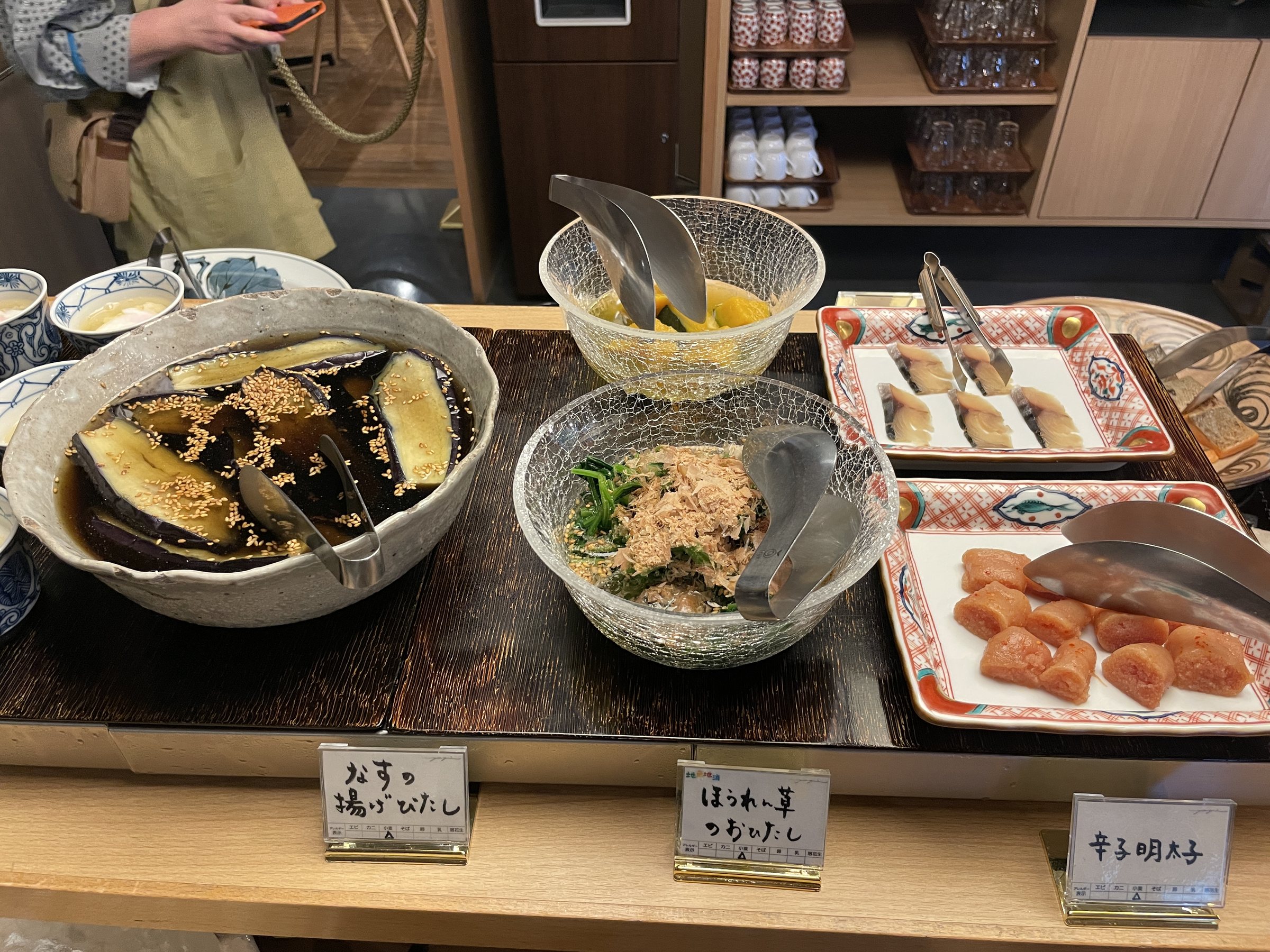 Simmered eggplant, a dressed salad and grilled salmon.