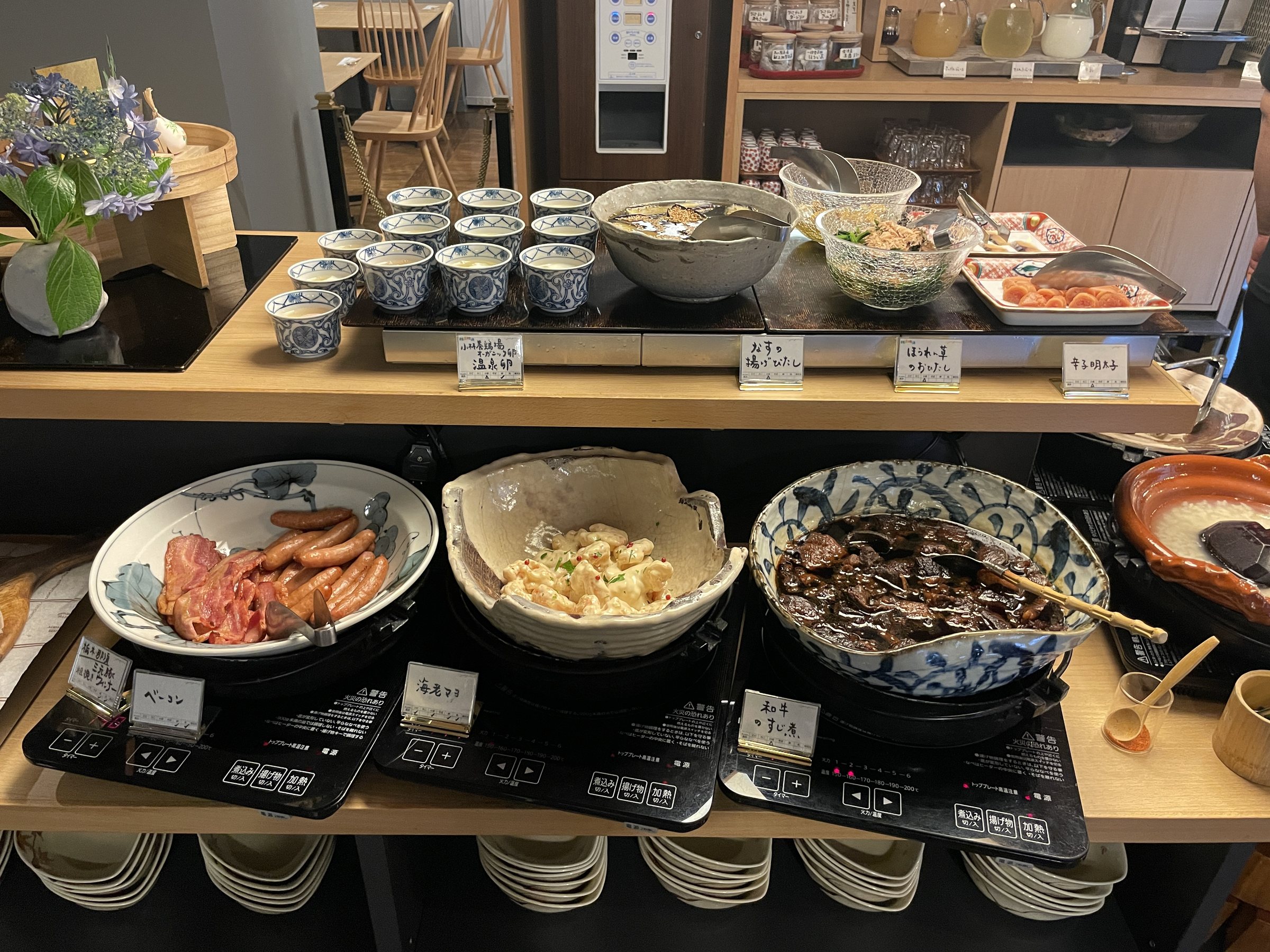 Hot dishes, including sausages, on the warming counter.