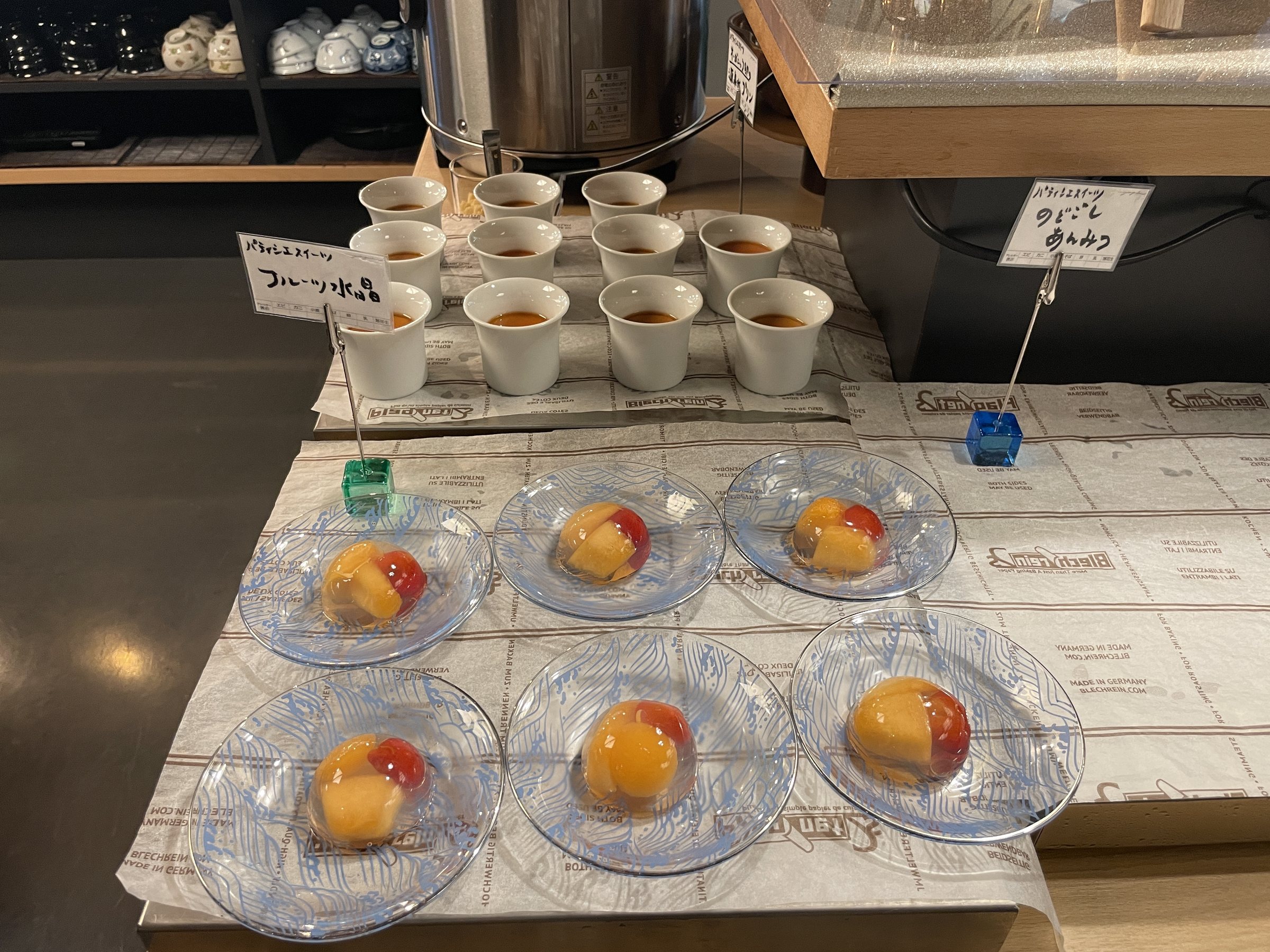Small glass dishes of fruit in jelly.