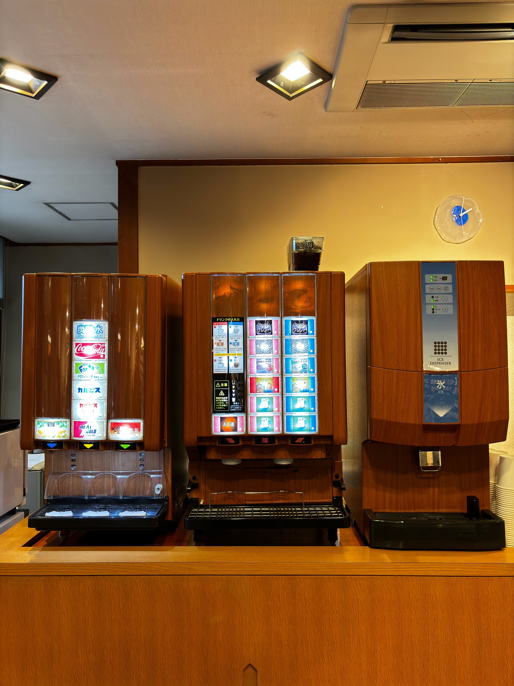 The lobby’s self-service drinks machines set into wooden cabinets.