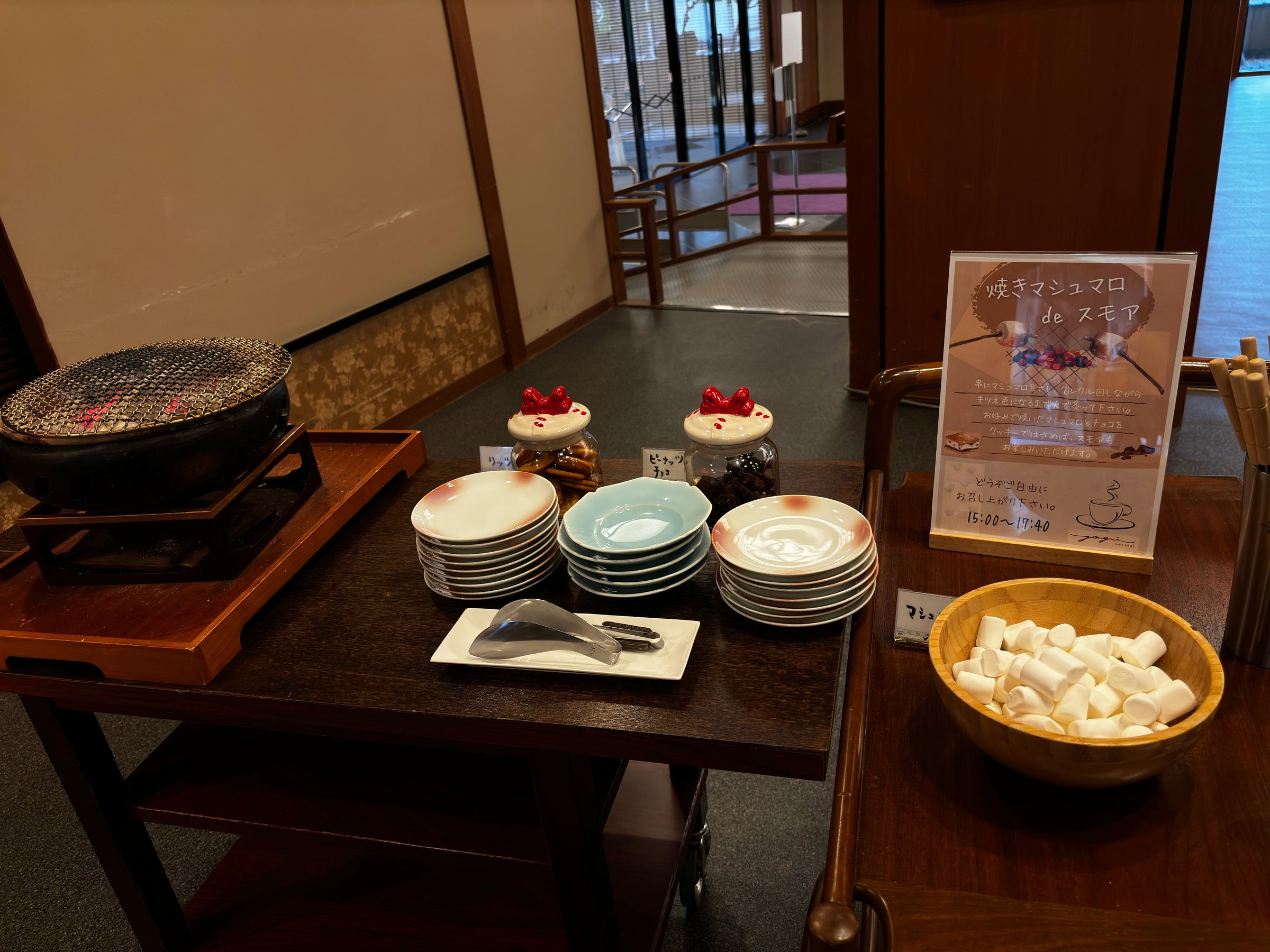 The s’mores station: a small grill, plates, marshmallows and an instruction card.