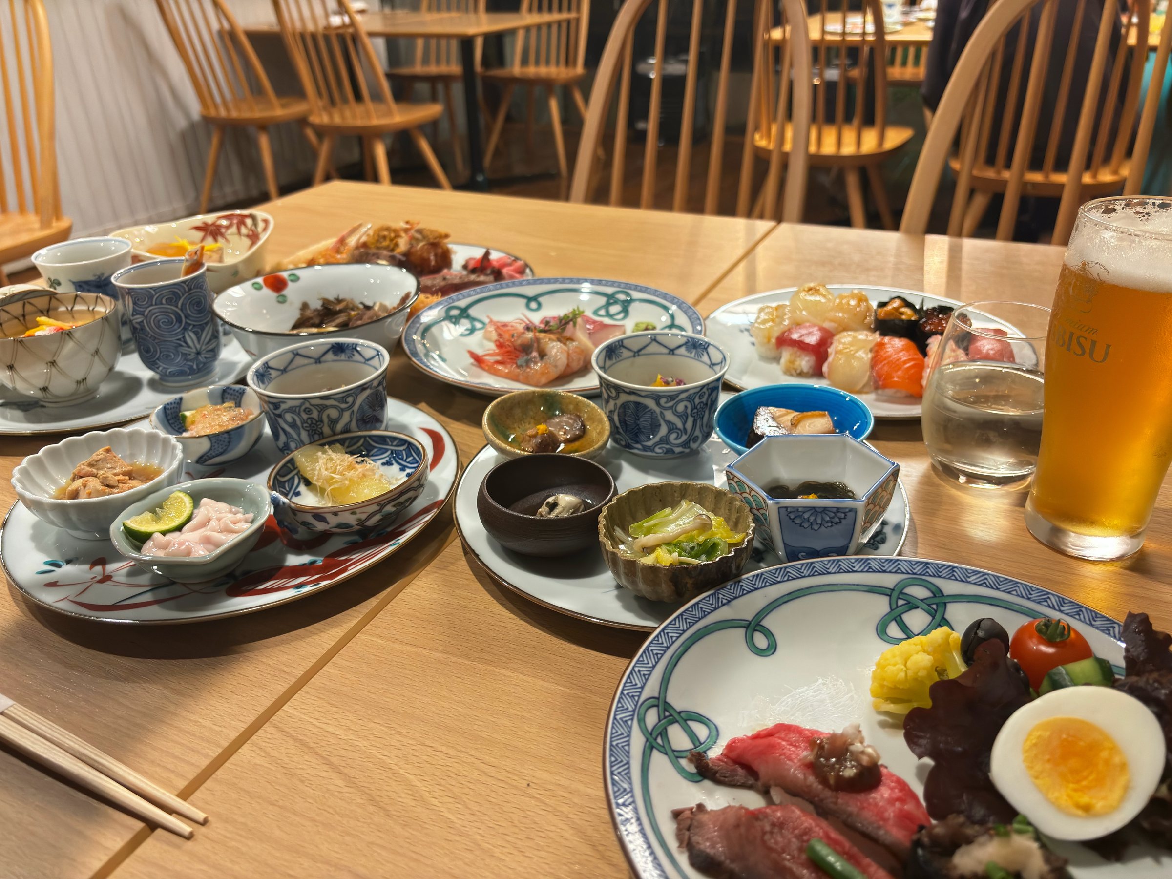 Our table: small bowls, sushi, roast beef and a glass of beer.