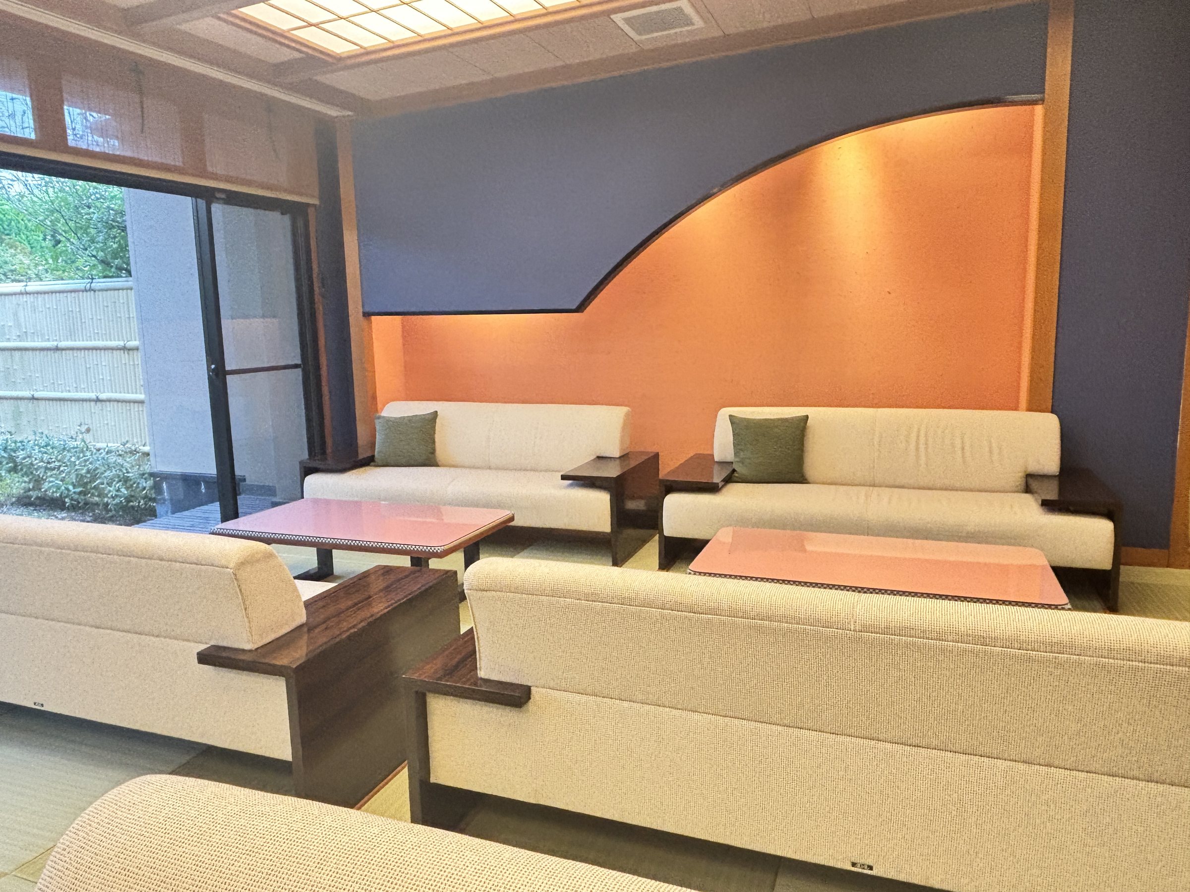 Sofas against a sweep of orange and blue wall.