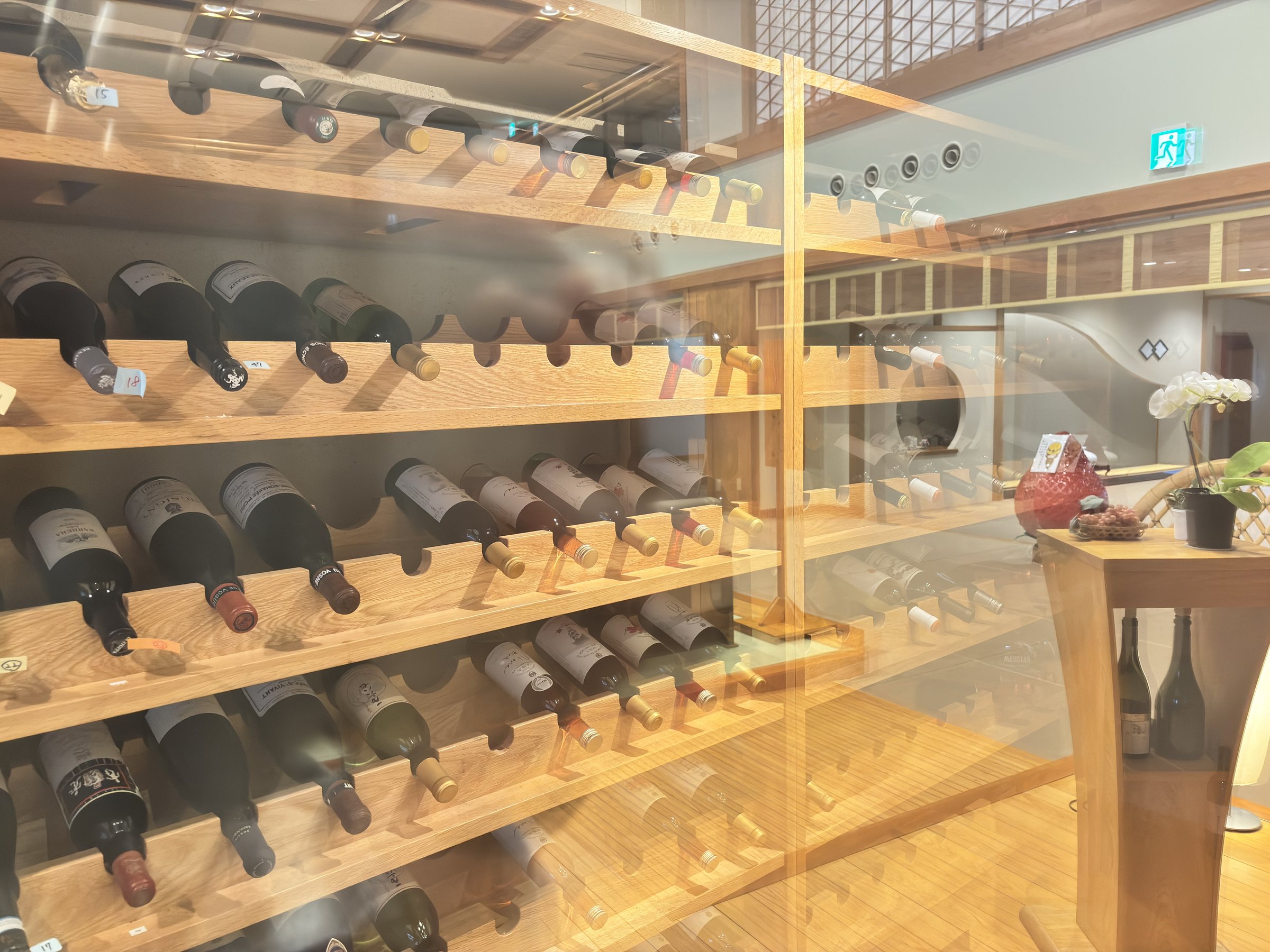 The wine cellar: rows of bottles on wooden racks.
